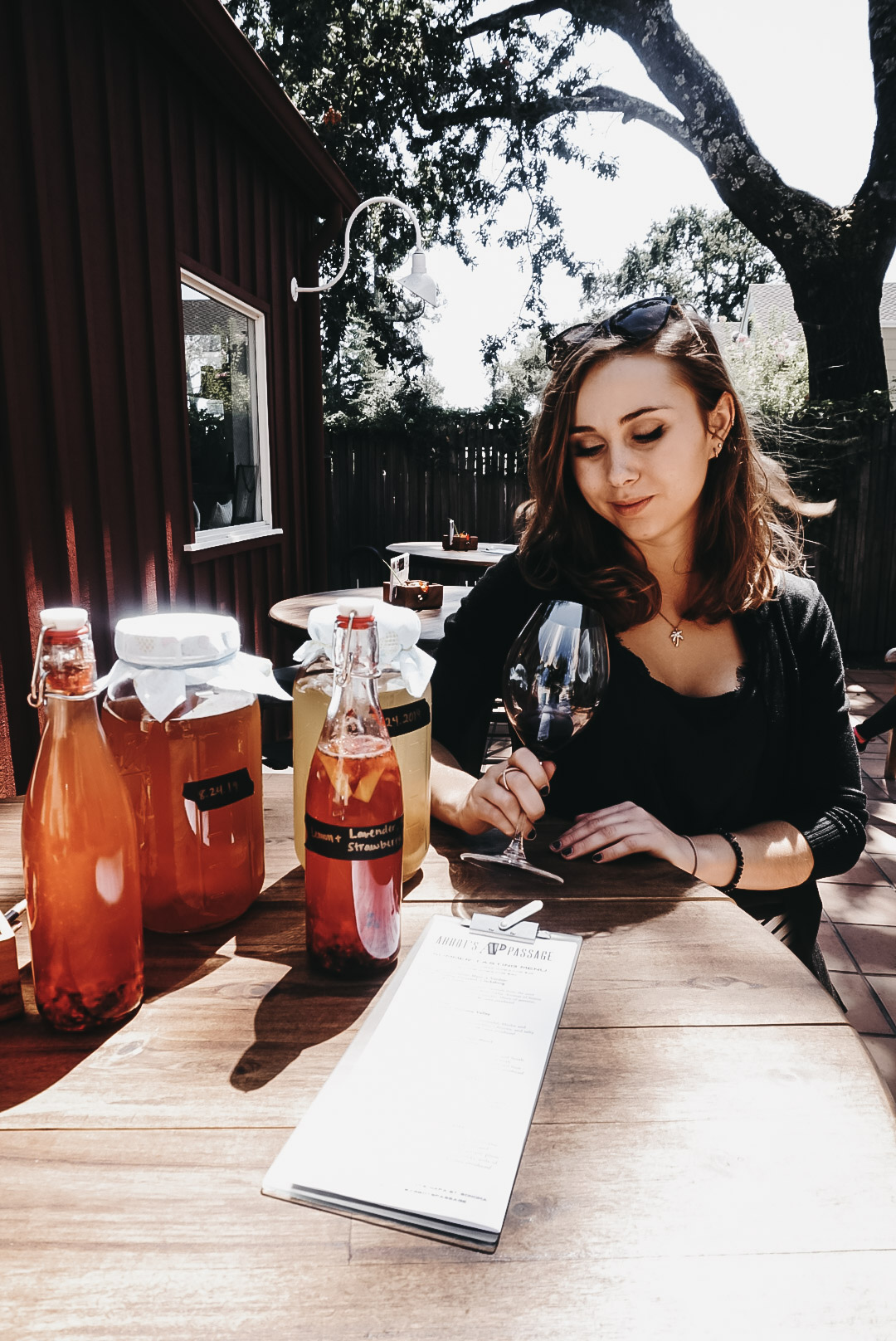 a girl tasting wine at Abbot's Passage