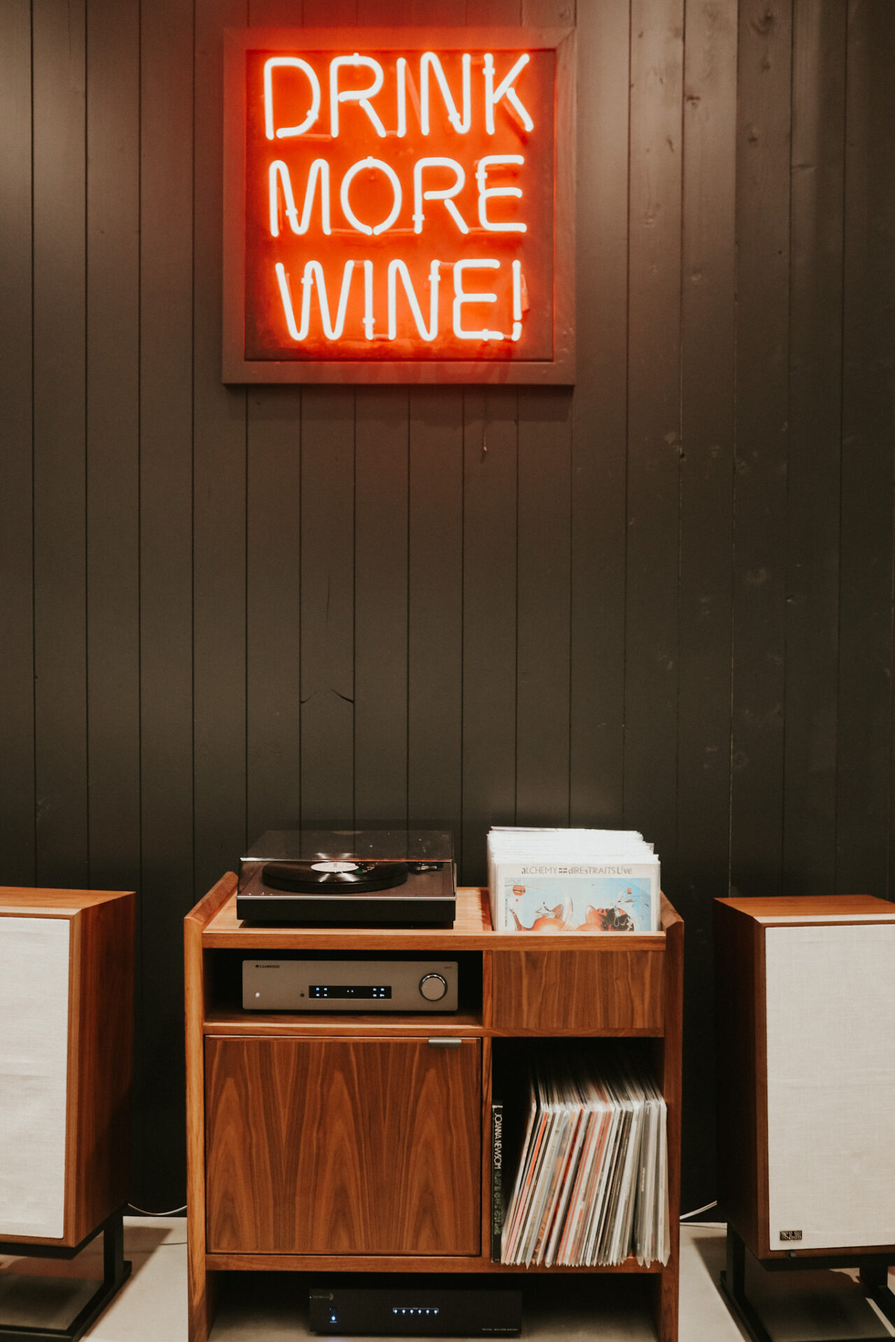 Record player and "Drink More Wine" LED sign in Compline Wine Shop downtown Napa