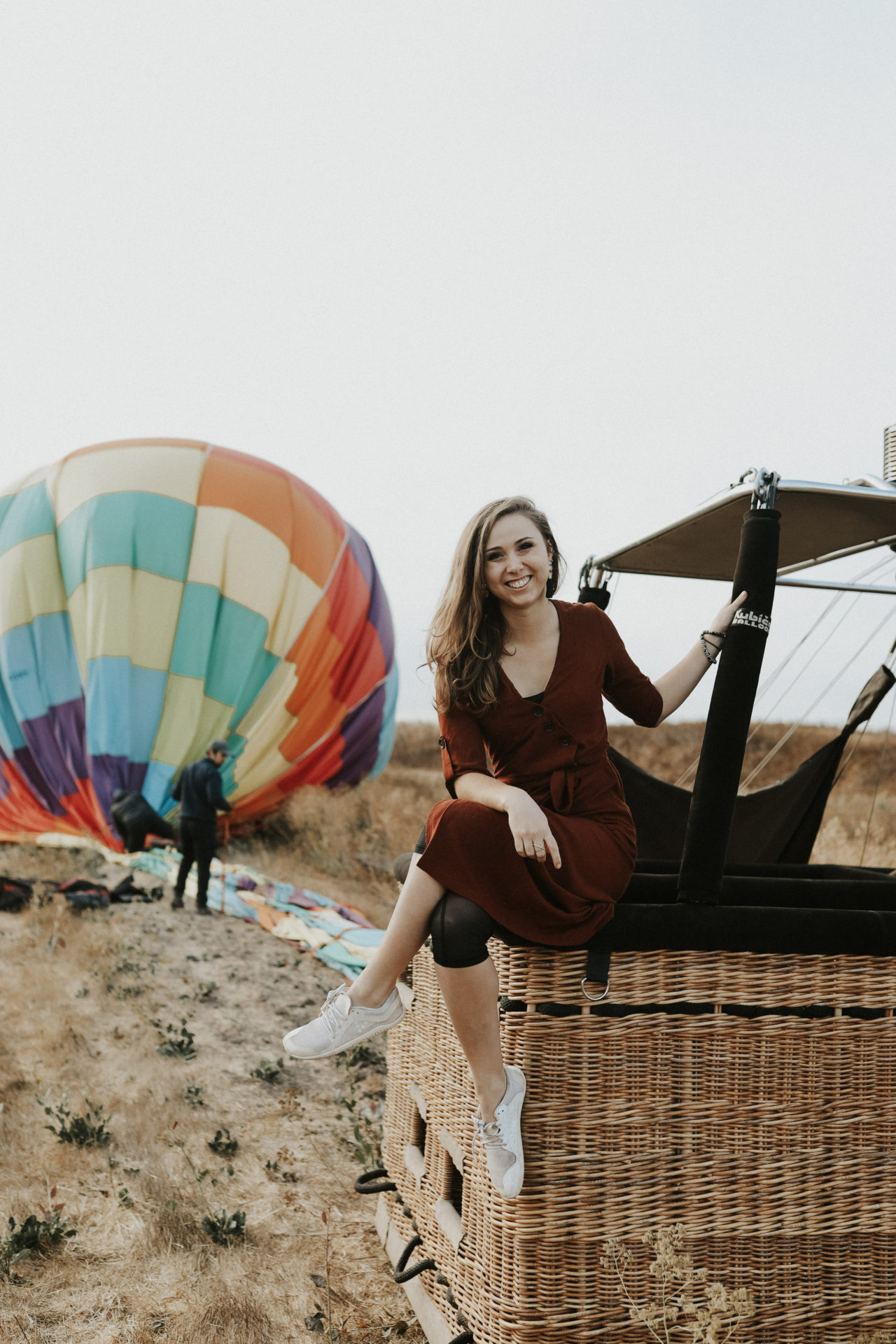 a girl sitting on a hot air balloon at hot air balloon Sonoma