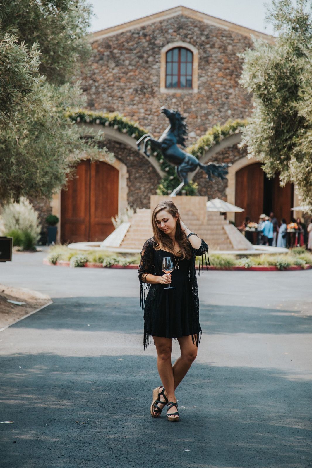 girl in front of the stallion statue at Black Stallion Winery