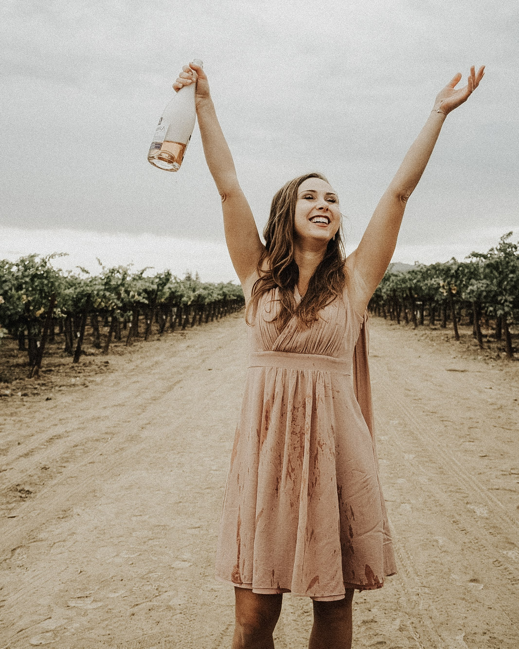 a girl with a bottle of wine