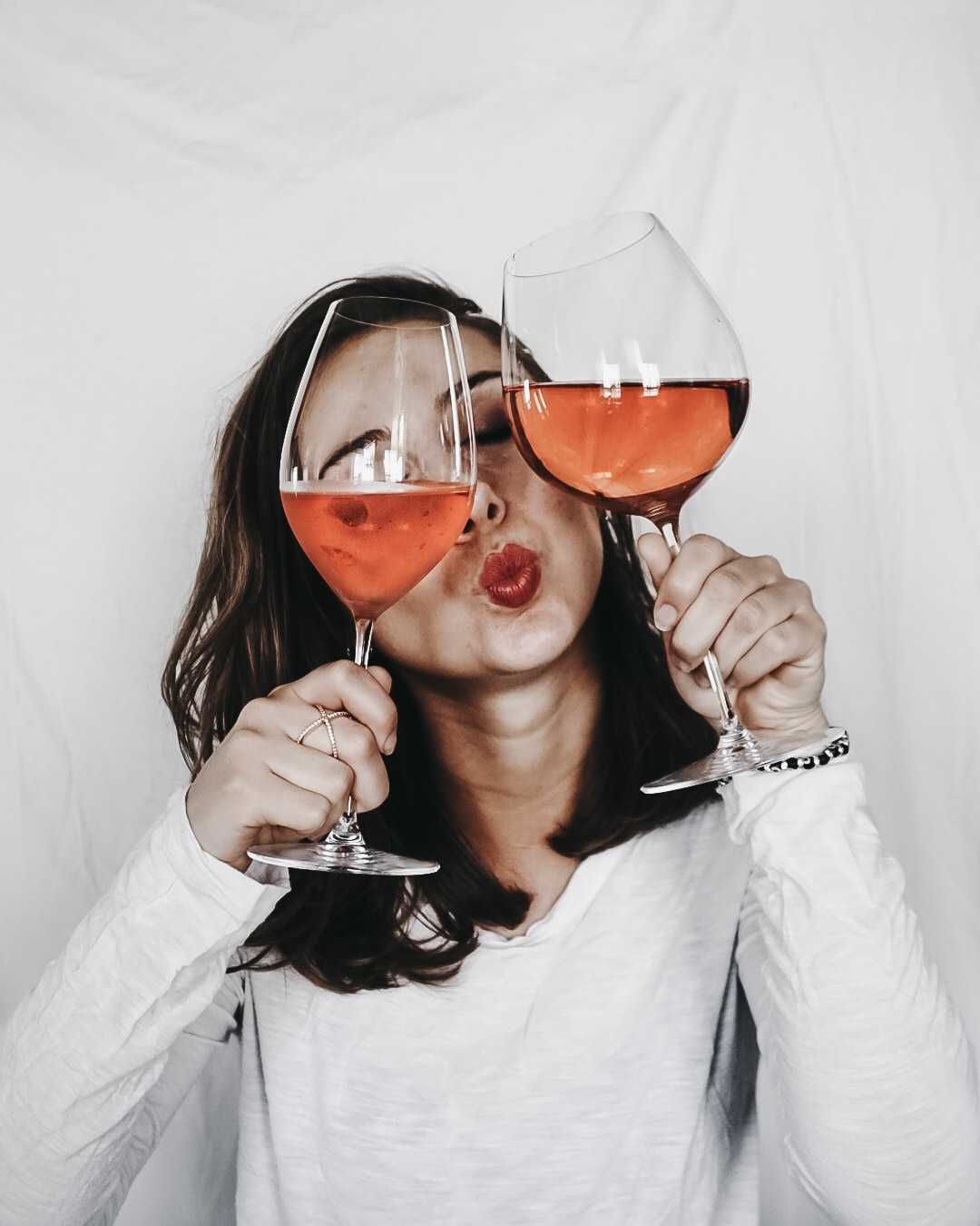 A girl posing with rose for an Instagram post including funny wine puns