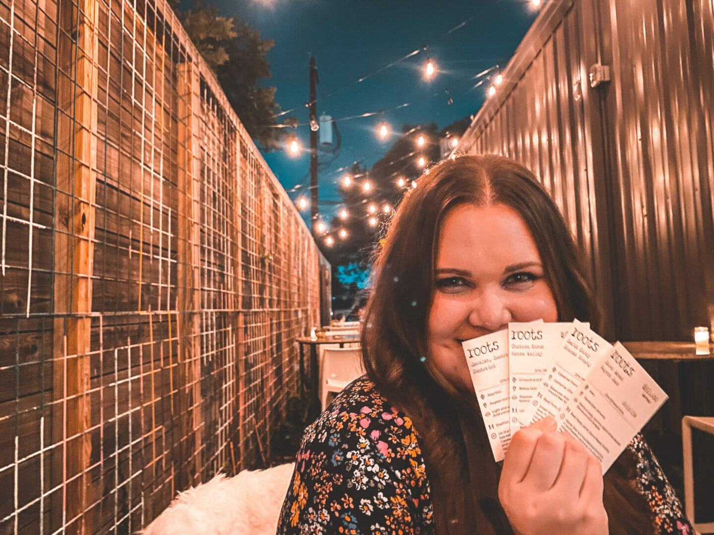 a girl outside of Roots, on a list of Houston wine bars