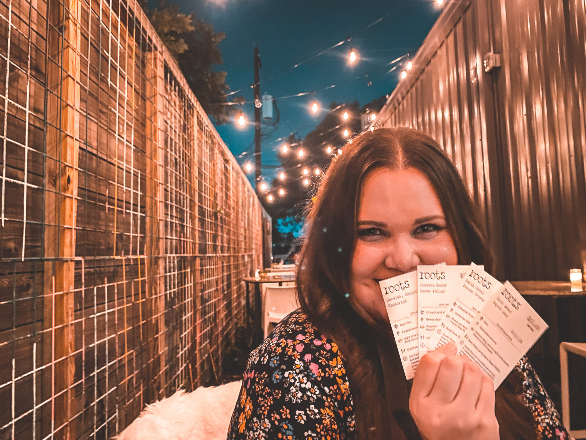 a girl outside of Roots, on a list of Houston wine bars