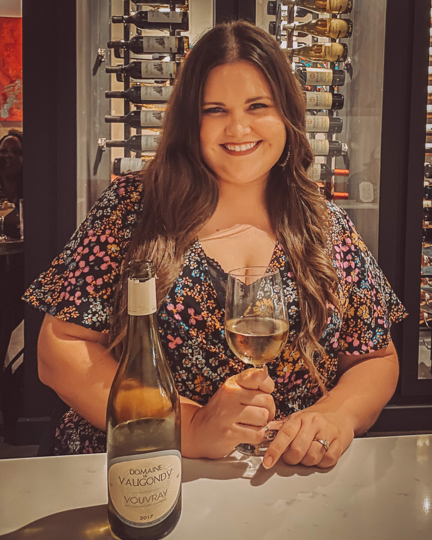 a girl with a glass of wine at Trez Art Wine Bar, on a list of Houston wine bars