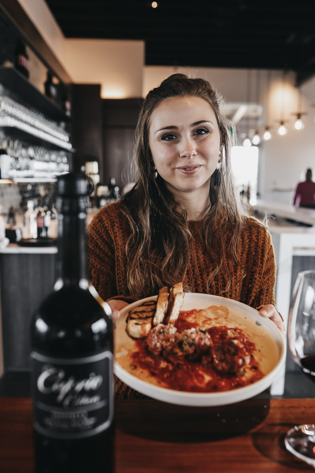 Paige holding meatballs at Caprio wine tasting