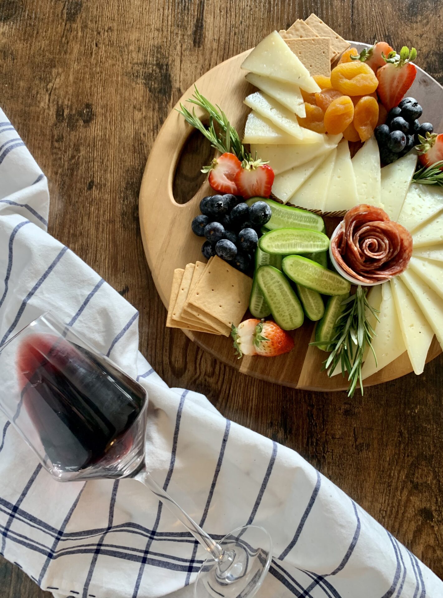 Simple Charcuterie Board with cheese and charcuterie roses with a glass of wine