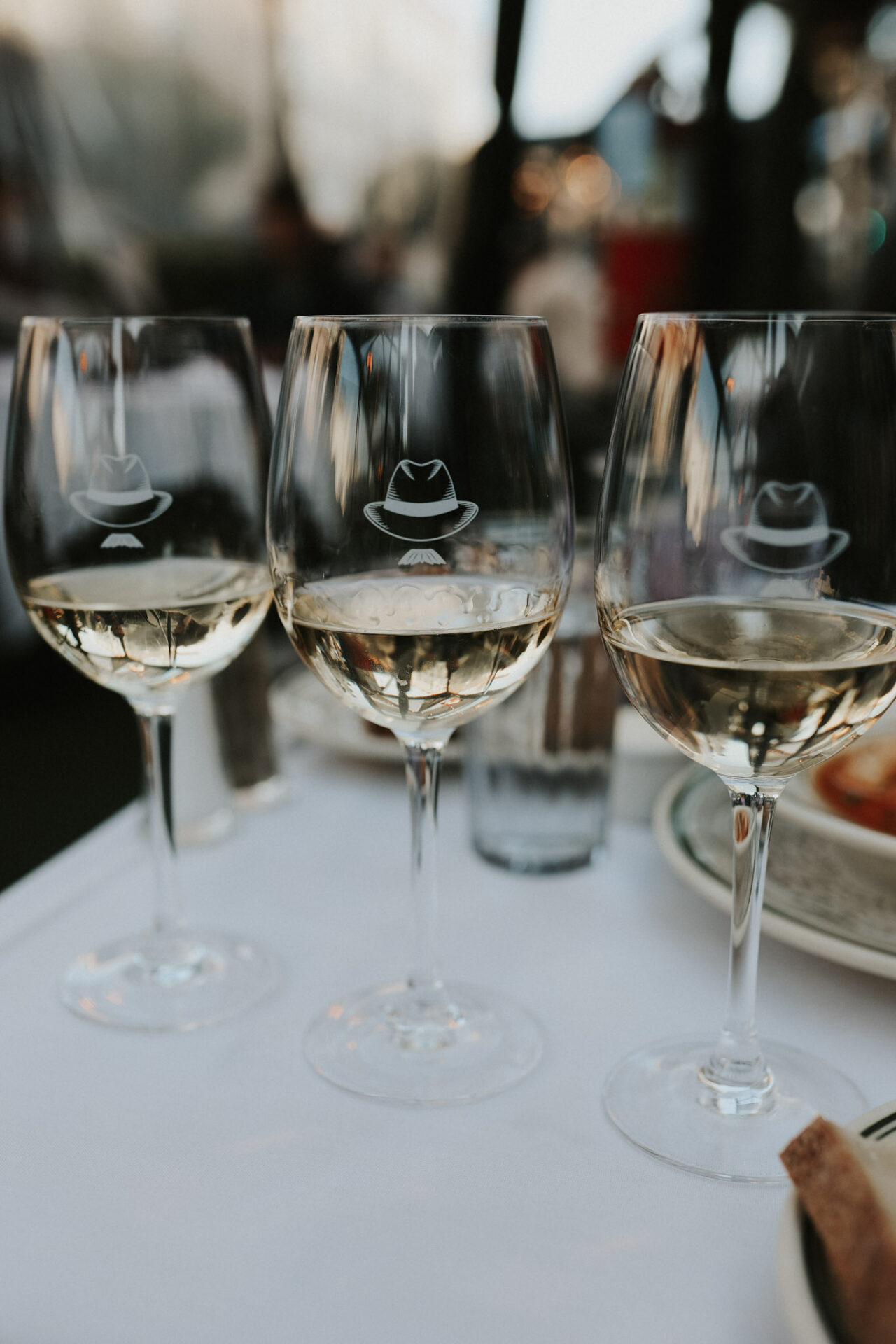 A flight of white wines at Izzys Steakhouse with cowboy hat glasses