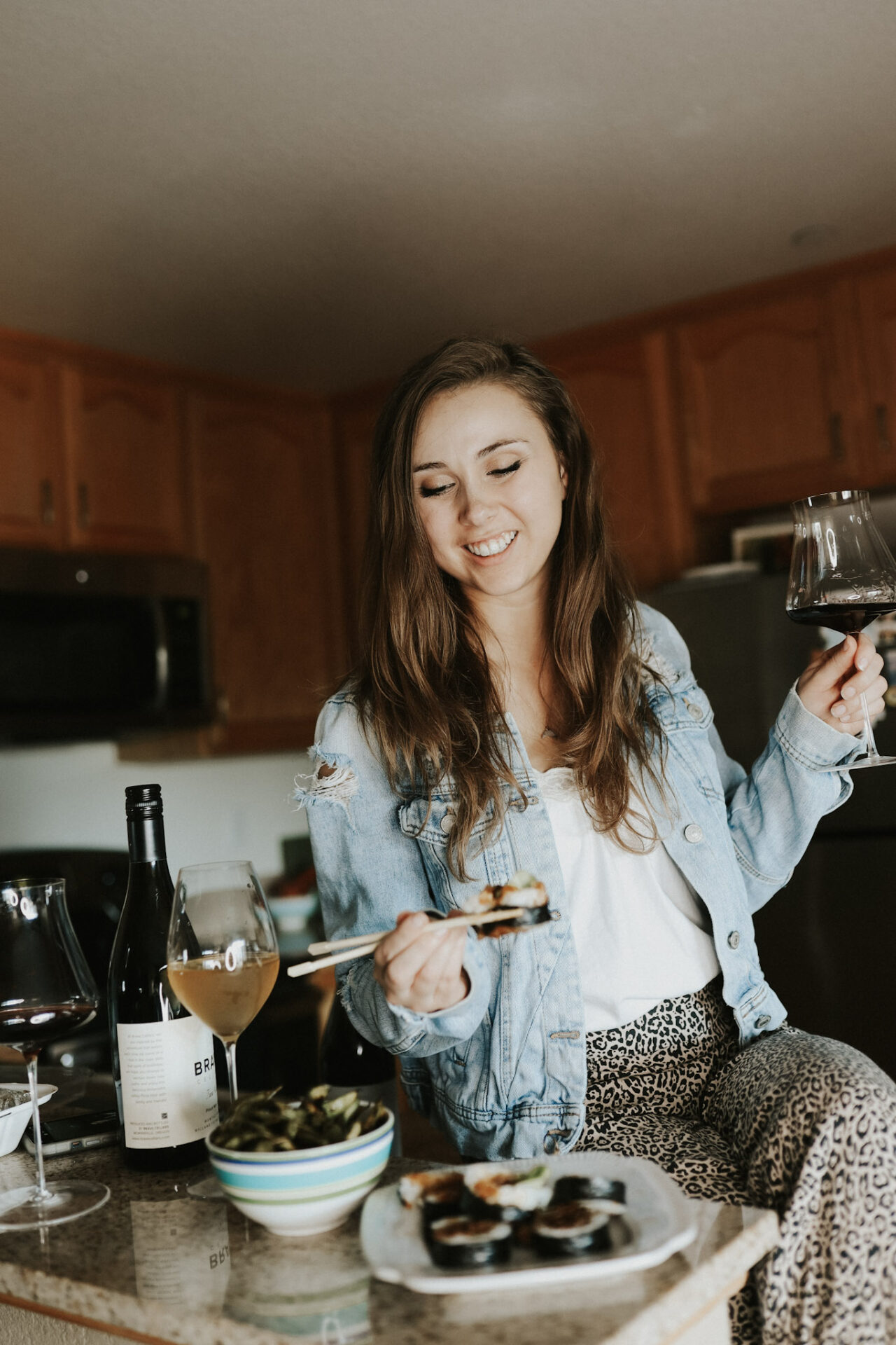 Paige eating sushi paired with wine