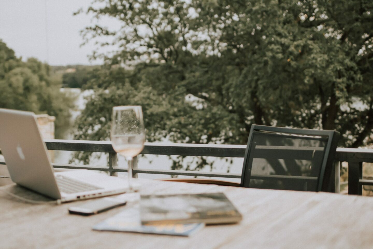 a laptop with a glass of wine, the cover for a blog post talking about winery marketing