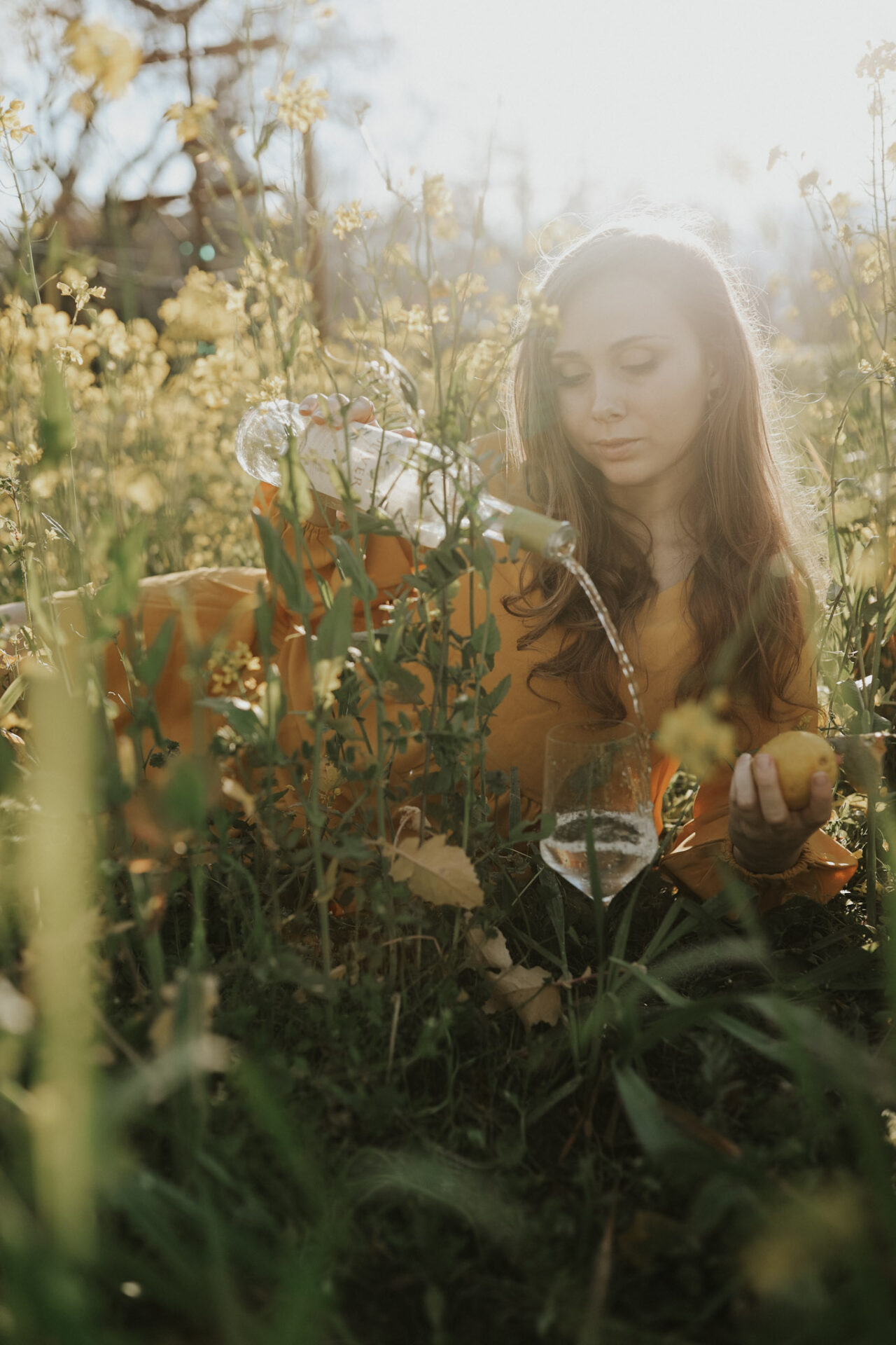 Paige drinks SIP Certified wine in a vineyard with yellow flowers