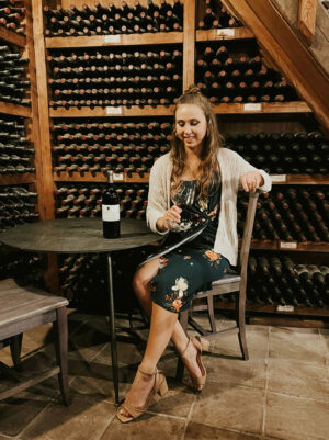 Sangiovese vs Chianti - Paige sipping Italian wines in a wine cellar