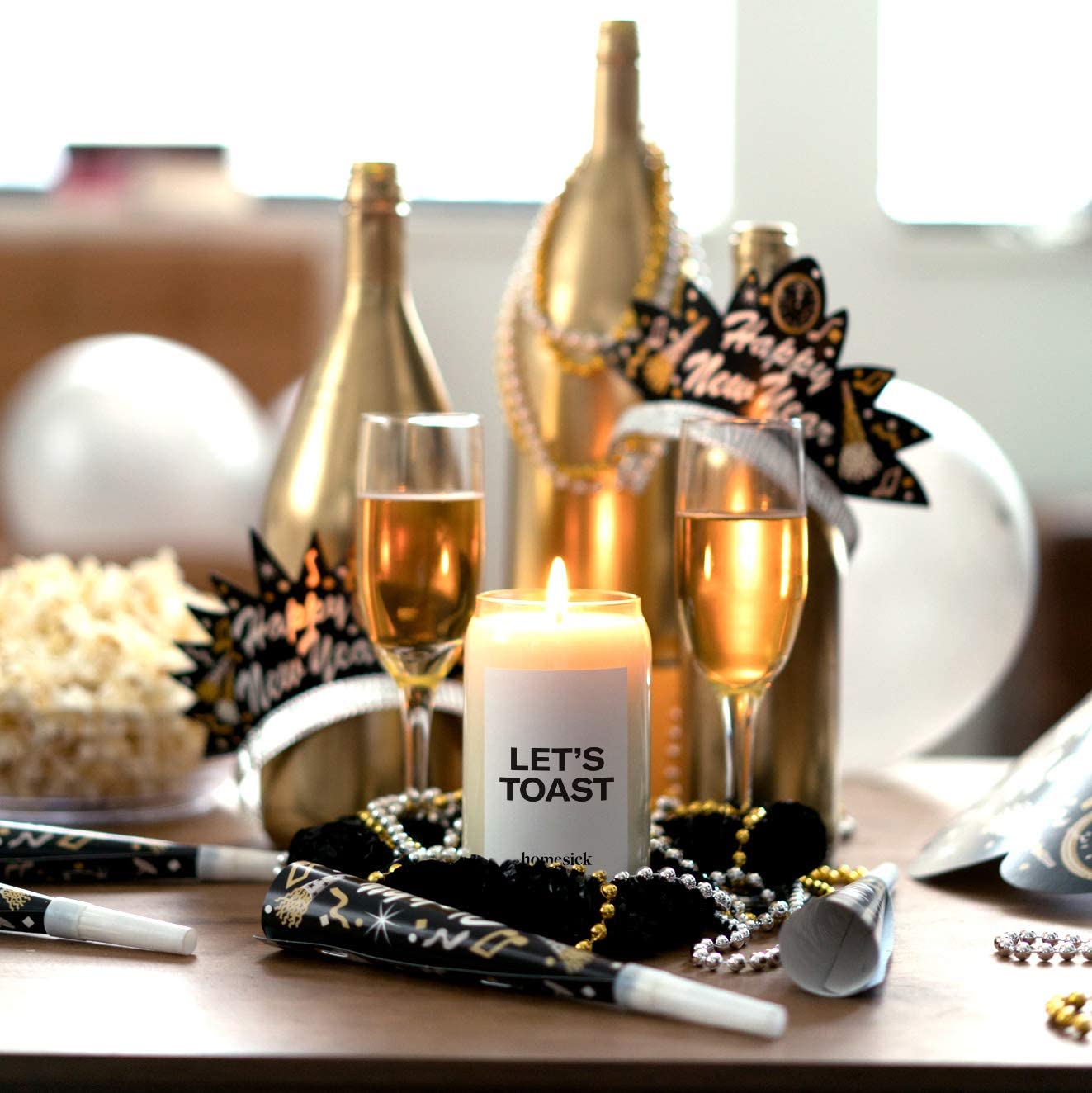 Wine Scented Candle Displayed in front of New Year's Eve Decorations
