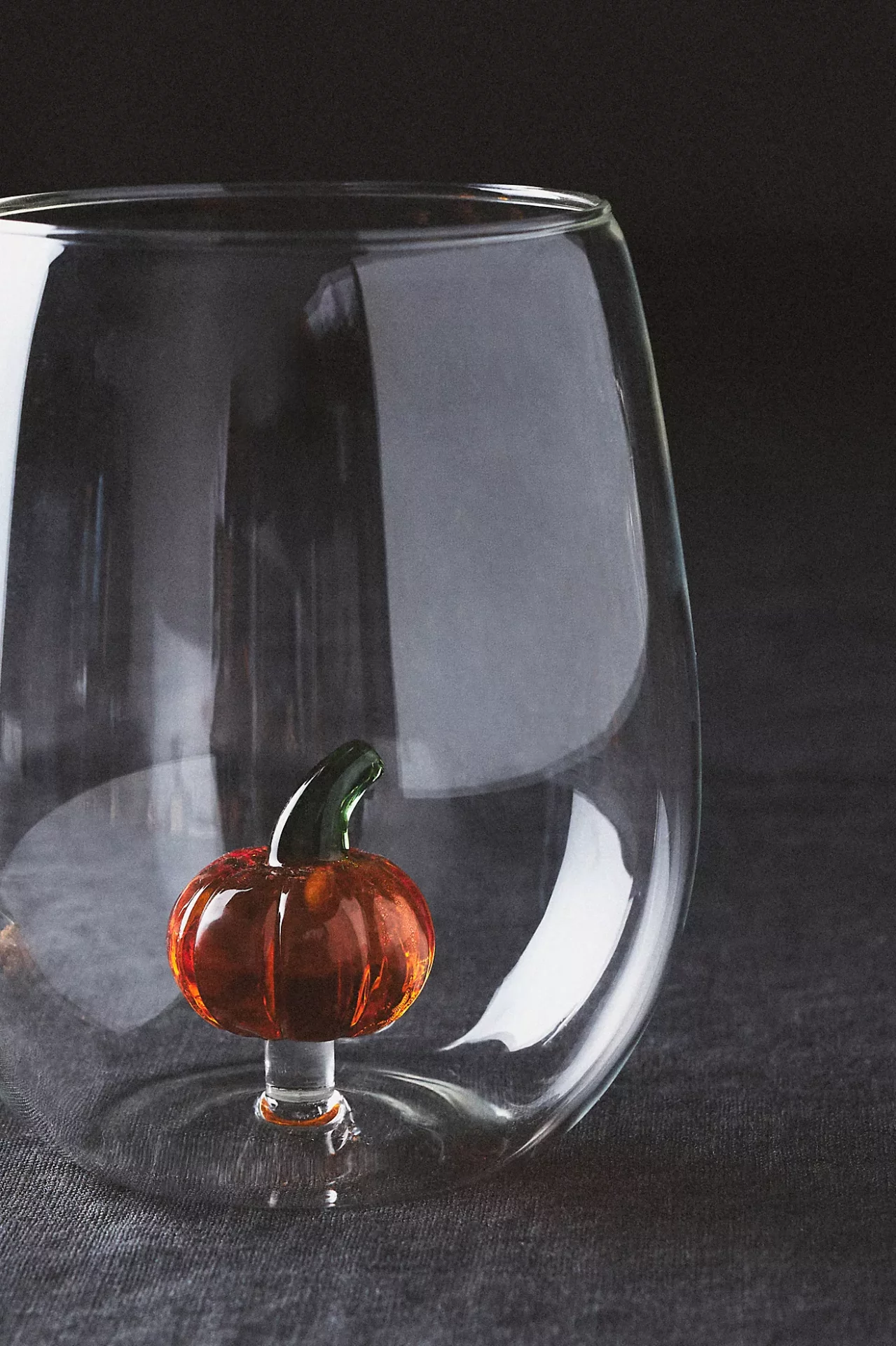 Stemless wineglass with submerged glass pumpkin inside
