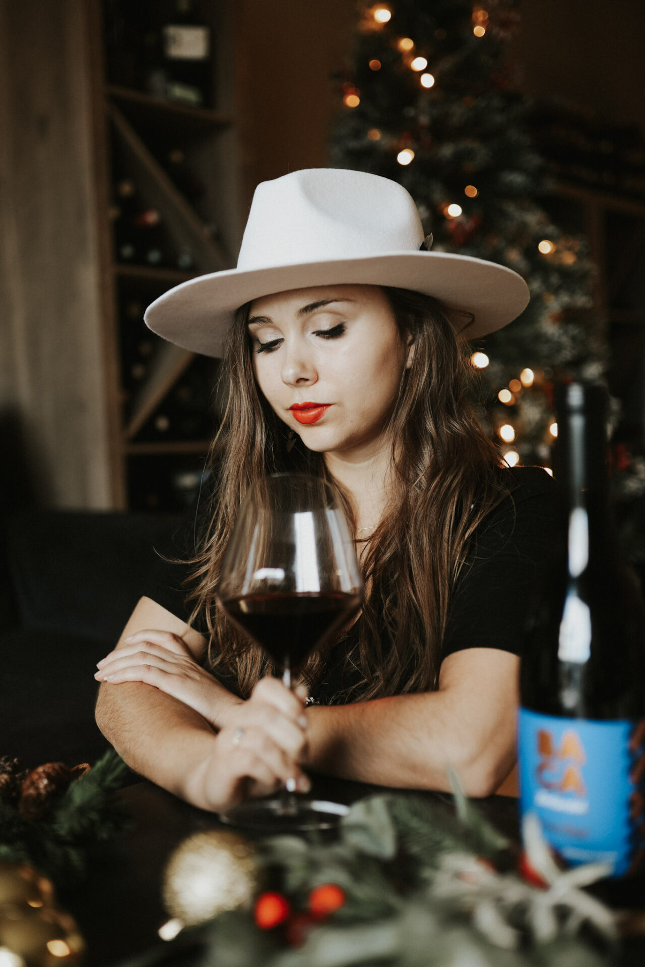 Paige wearing a white "My Wine Hat" hat