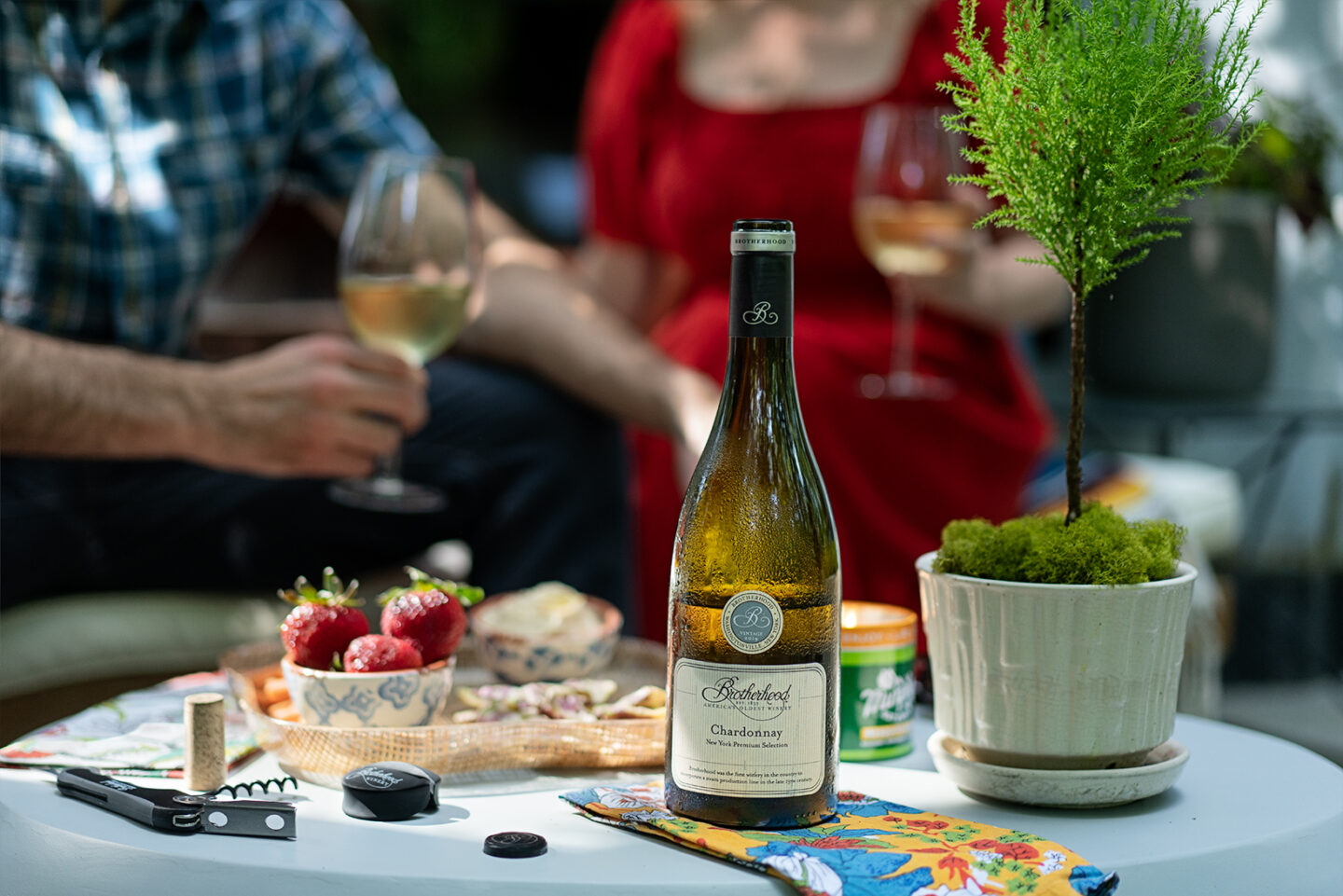 Bottle of wine placed with cheese and berries