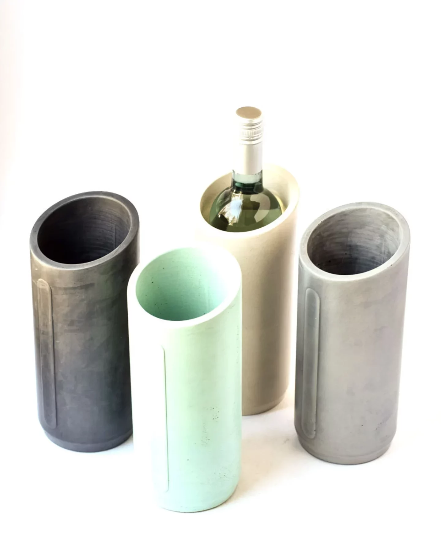 Four concrete wine chillers in varying colors