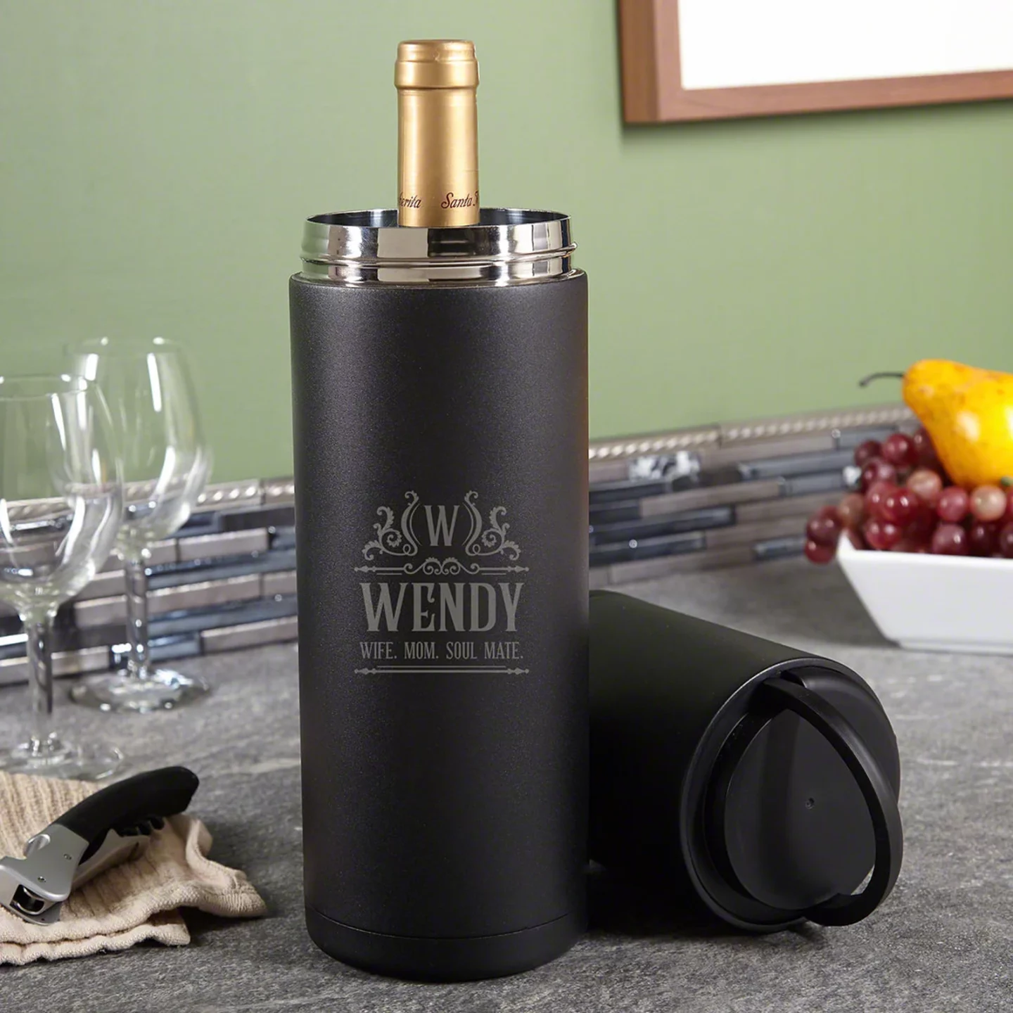 Black, engraved and portable wine chiller holding a bottle of wine