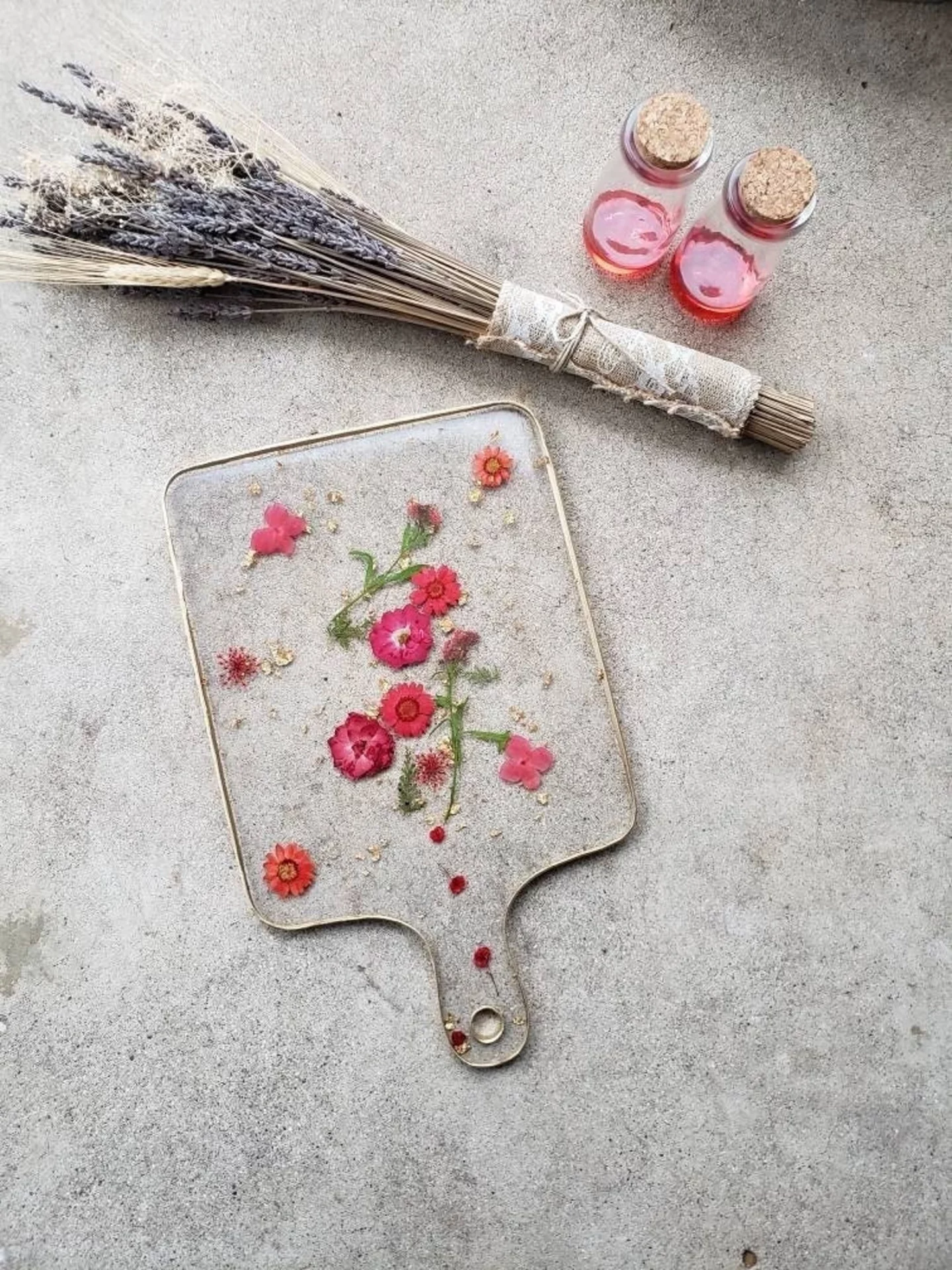 Epoxy charcuterie board with dried red flowers