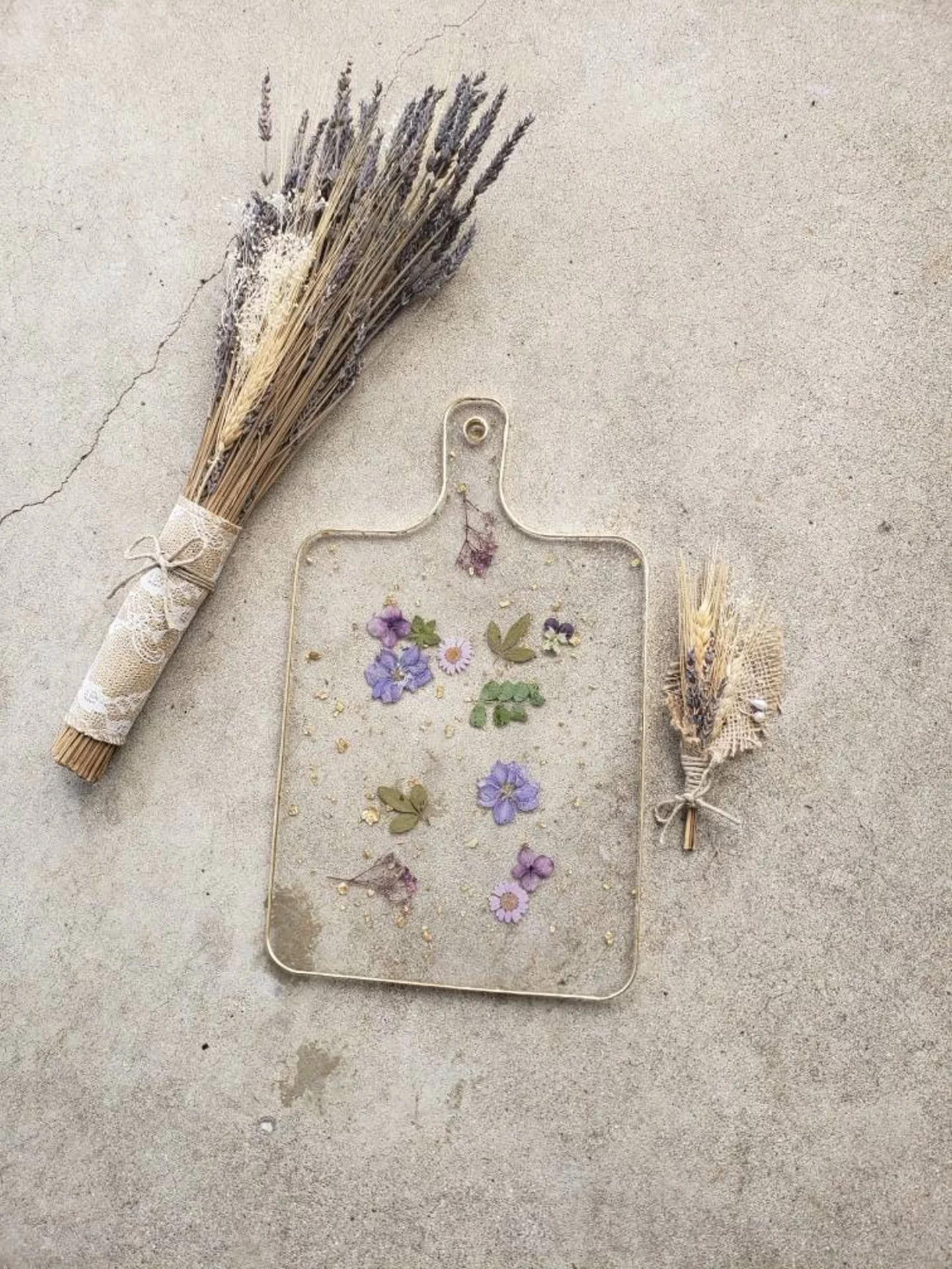 Epoxy charcuterie board with purple dried flowers