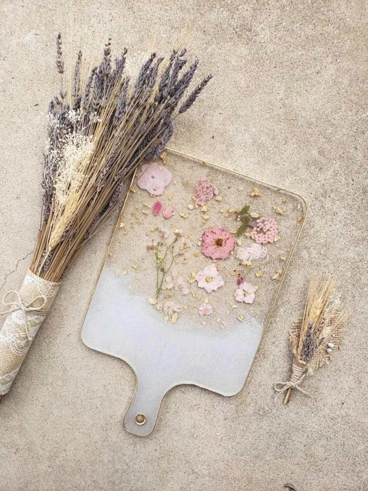 Epoxy charcuterie board with assortment of dried wild flowers