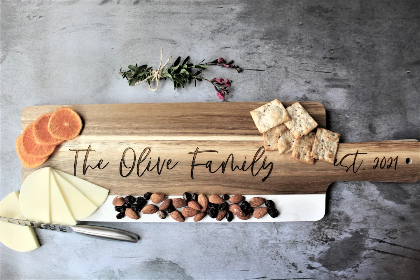 Nuts, crackers and cheese plated on personalized charcutiere board of wood and marble