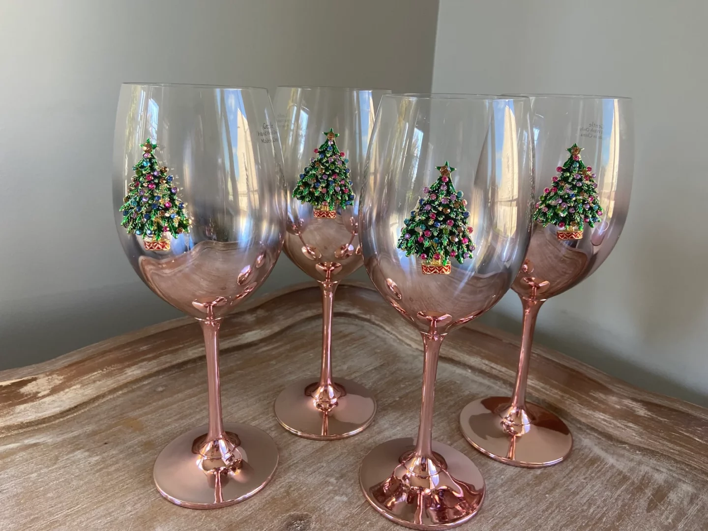 Metallic Pink wine glasses featuring bedazzled Christmas trees