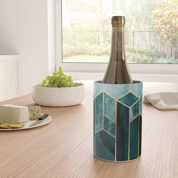 Teal and hexagon designed wine chiller holding a bottle on a dining room table