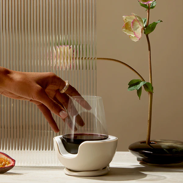 Hand holding a stemless wine glass in a VoChill Wine Chiller