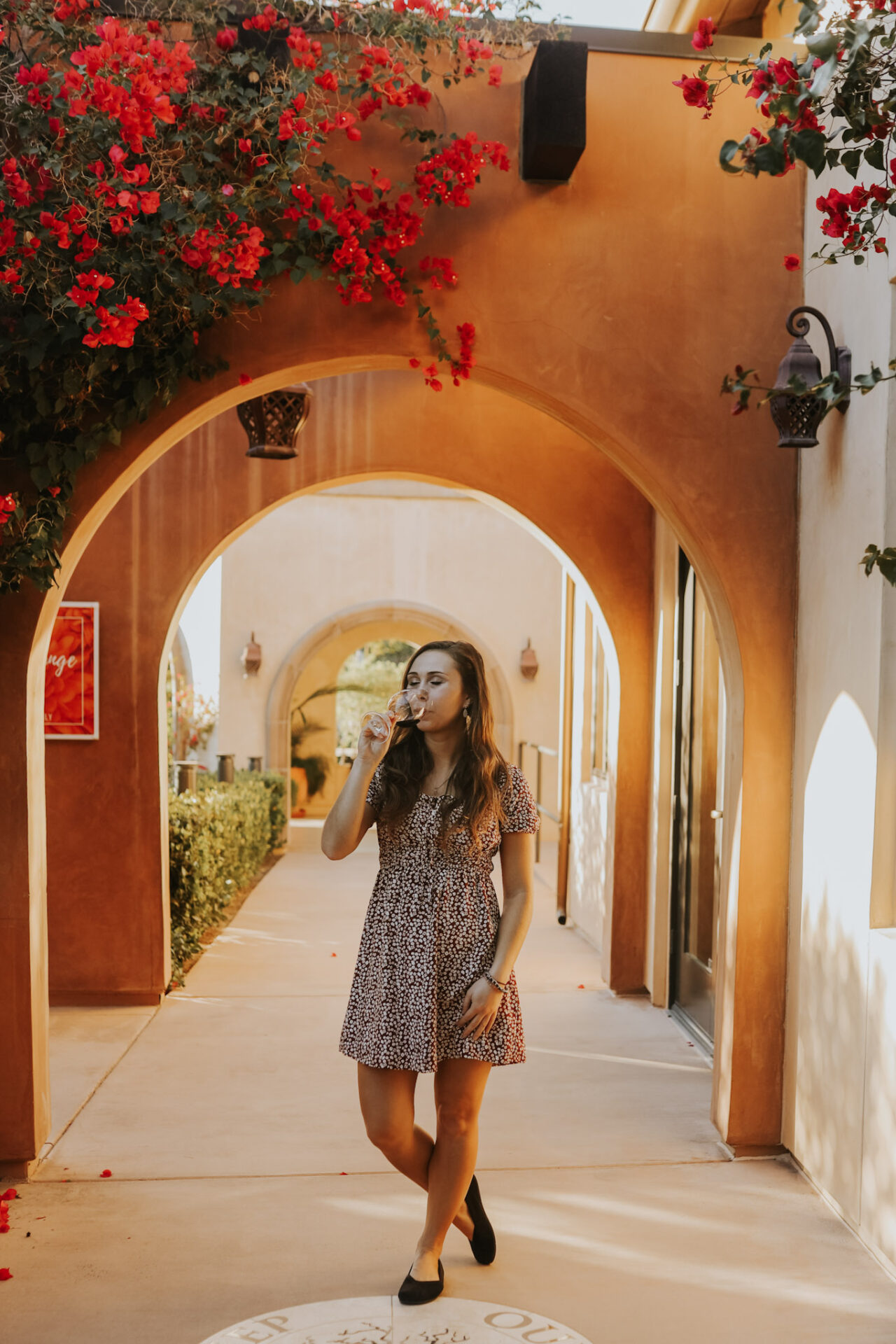 Paige at Fazeli Winery in Temecula, surrounded by pink flowers