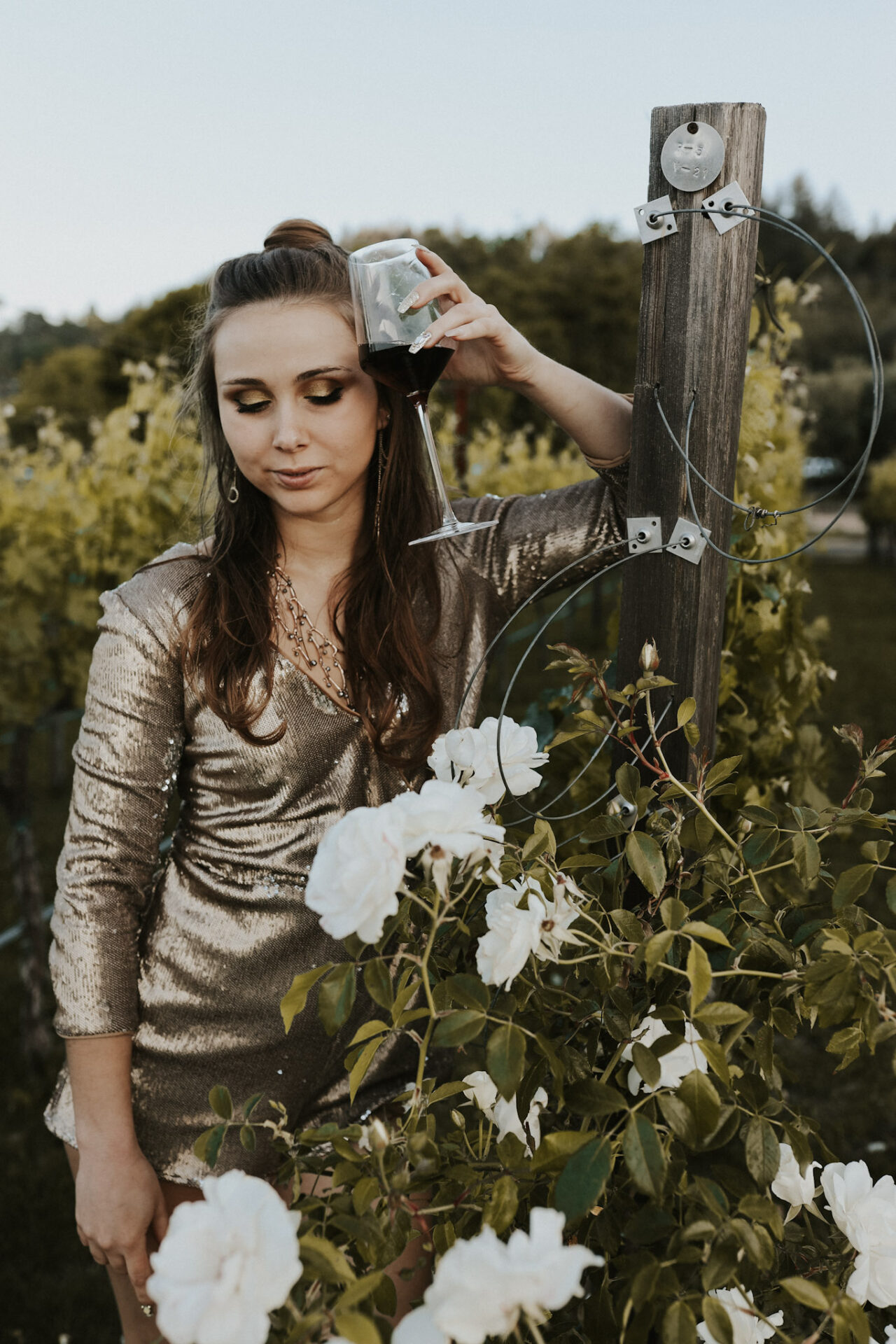 Paige in a vineyard holding a glass of the best Cabernet Sauvignon