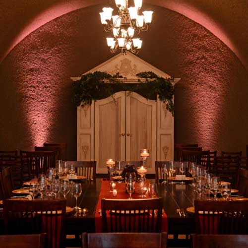 The Cave at Oak Mountain Winery in Temecula, set with tables and a chandelier