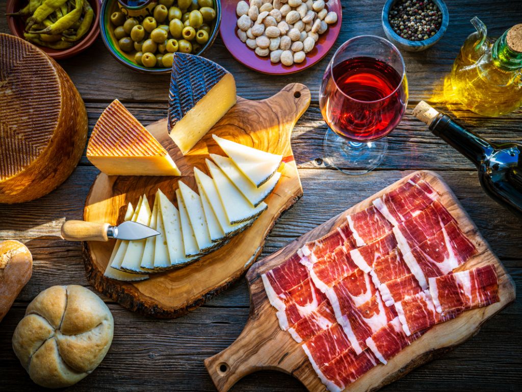 Shiraz vs Syrah food pairings - red wine on a table with spanish meat and cheese