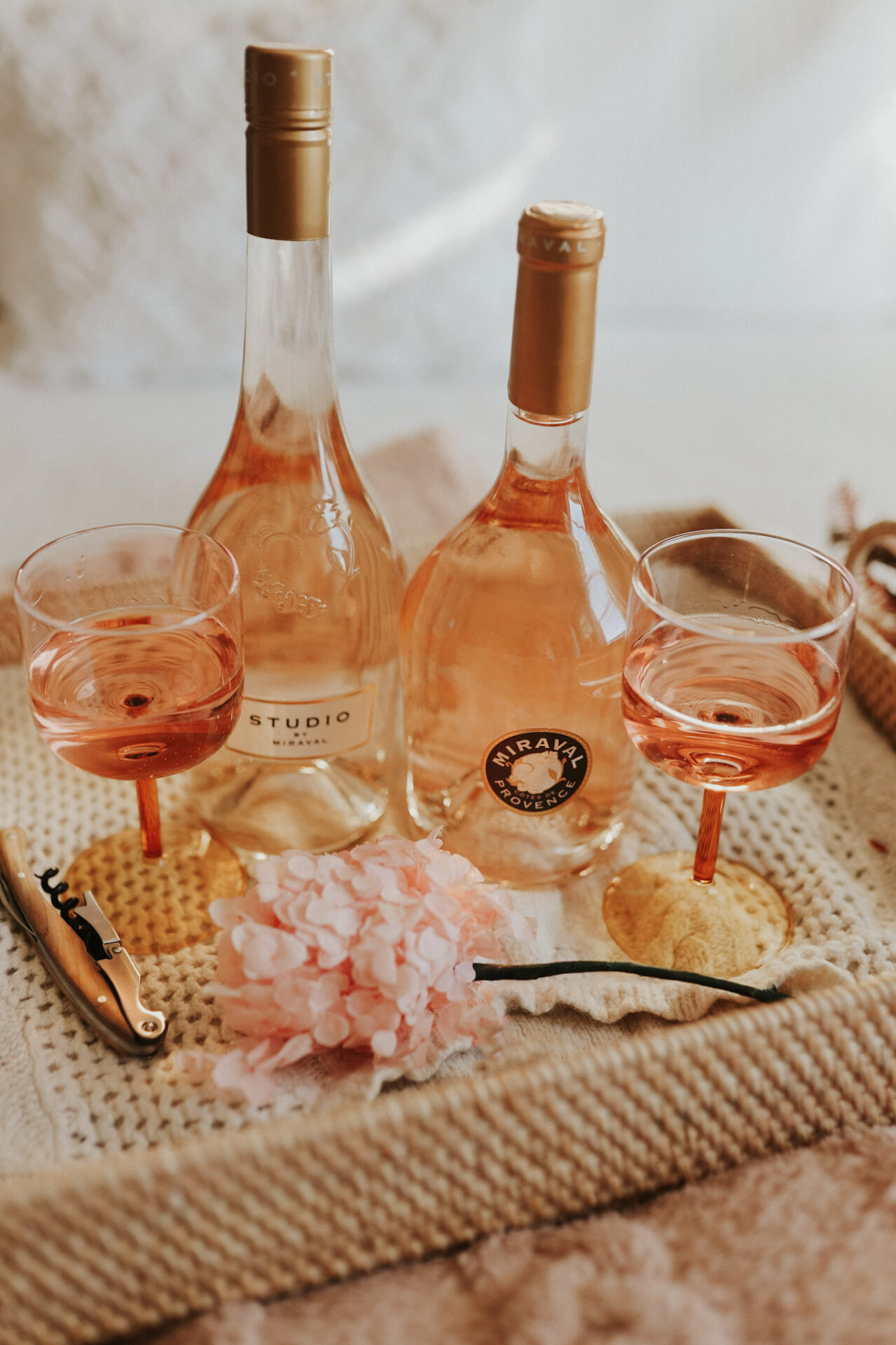 Miraval rose wine bottles with wine glasses