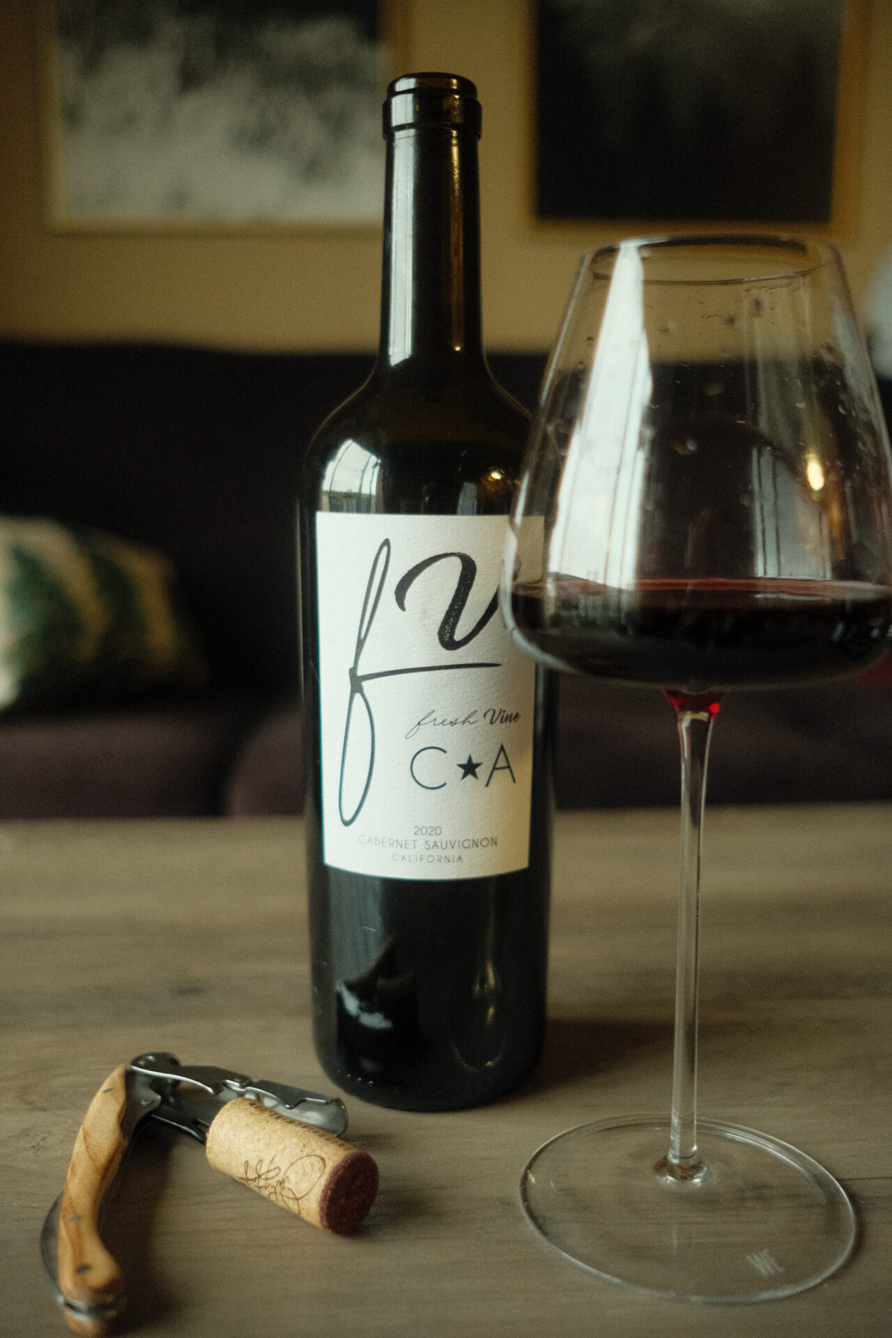 Fresh Vine Wine Cabernet Sauvignon Wine Bottle and glass with corkscrew