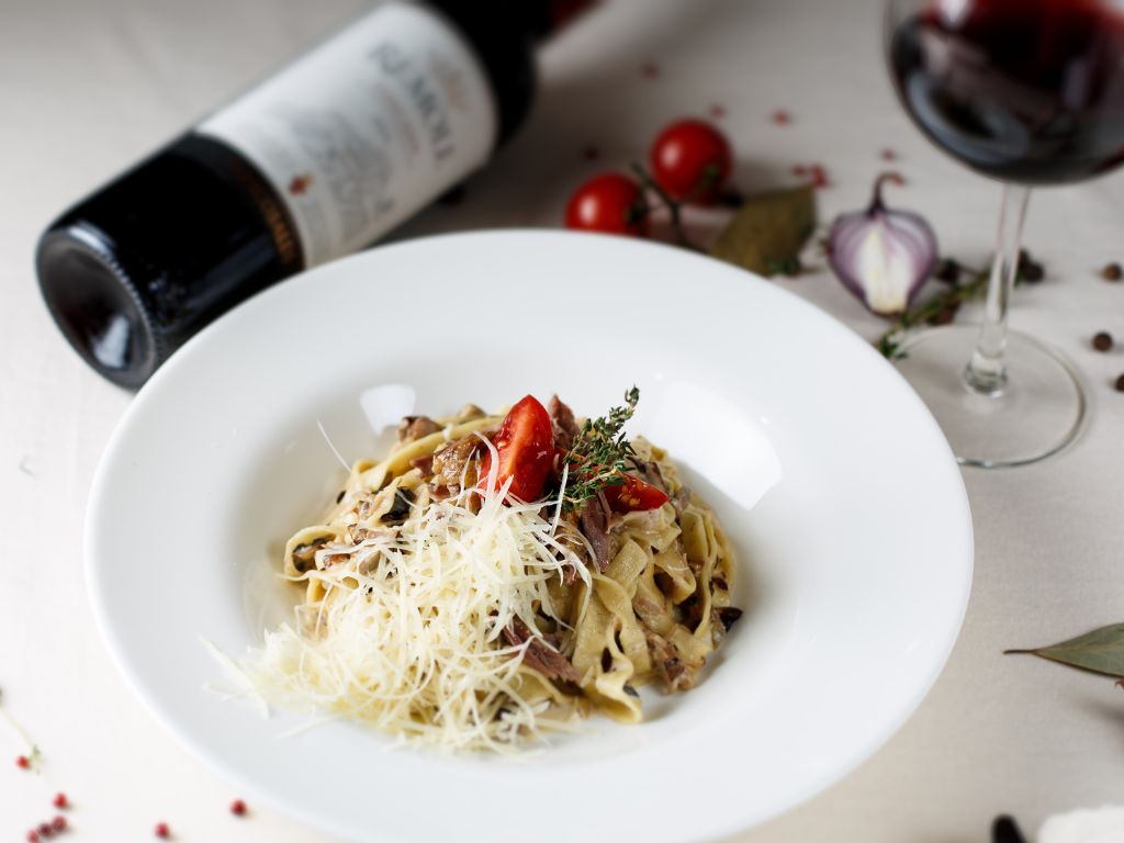 A glass of corvina wine paired with italian pasta