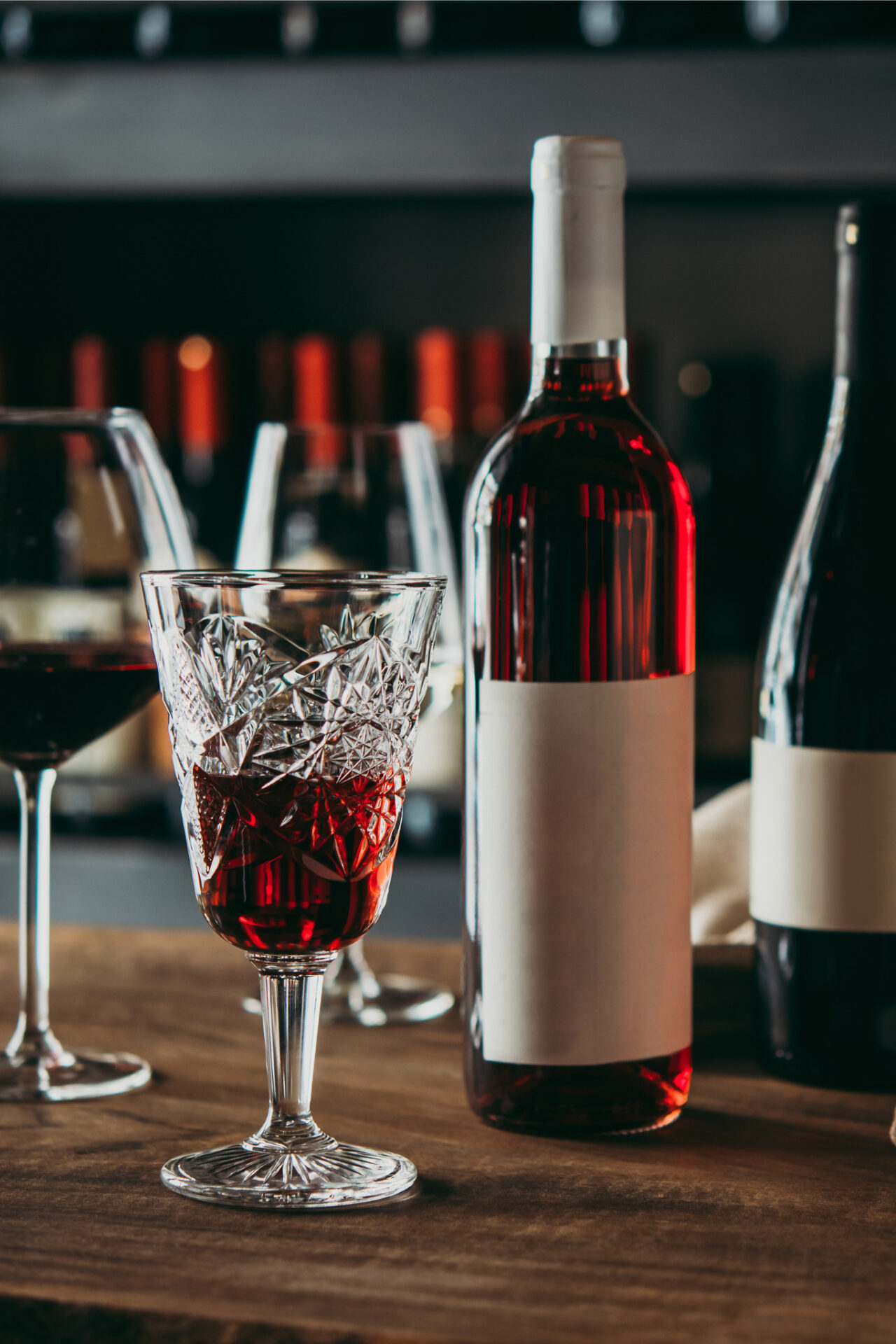 Muscadine Wine bottles next to filled wine glasses