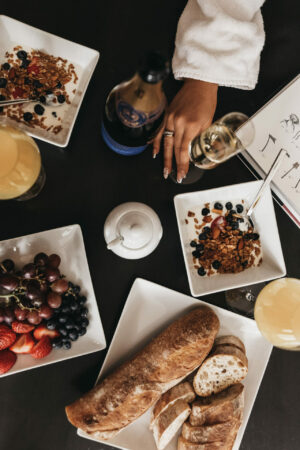 The best prosecco for mimosas with woman's hand over breakfast foods