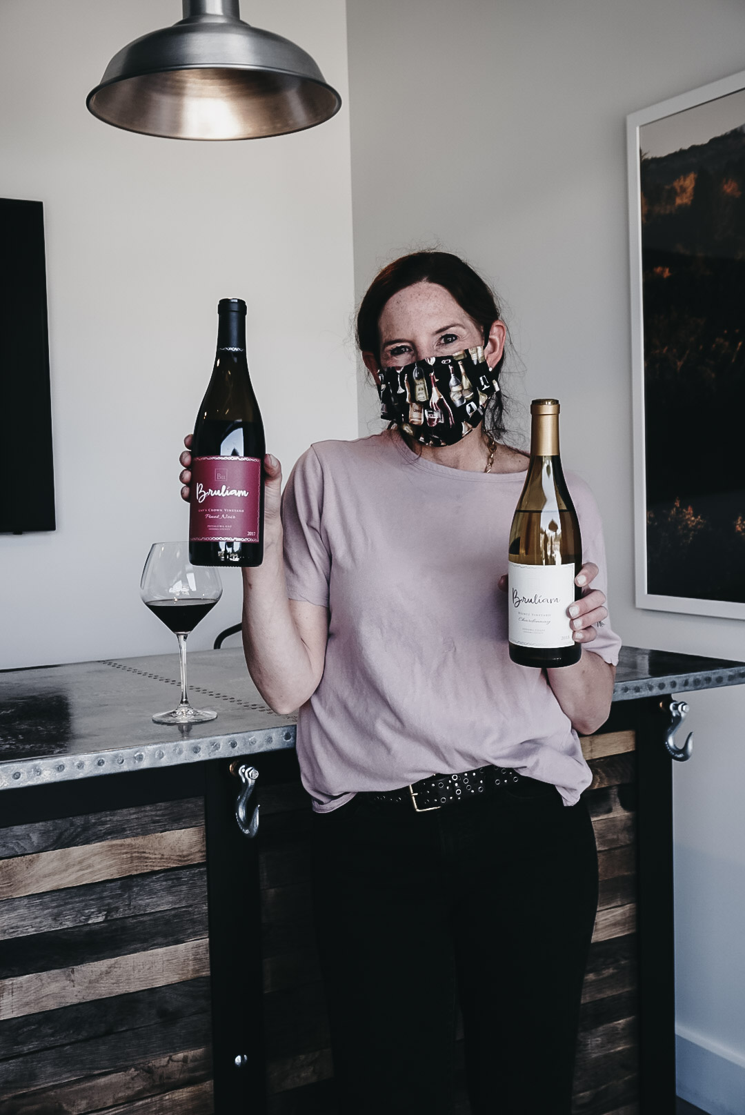 Kerith Overstreet posting with two bottles of her own Bruliam wine
