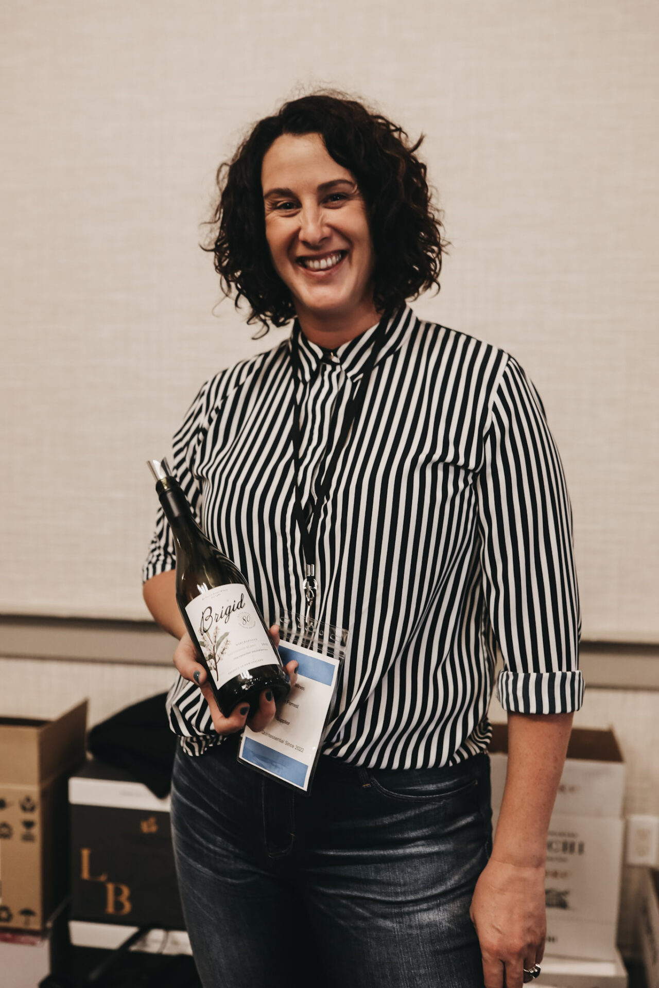 Beth Forrest of Forrest Wines holds a bottle of Brigid Sauvignon Blanc