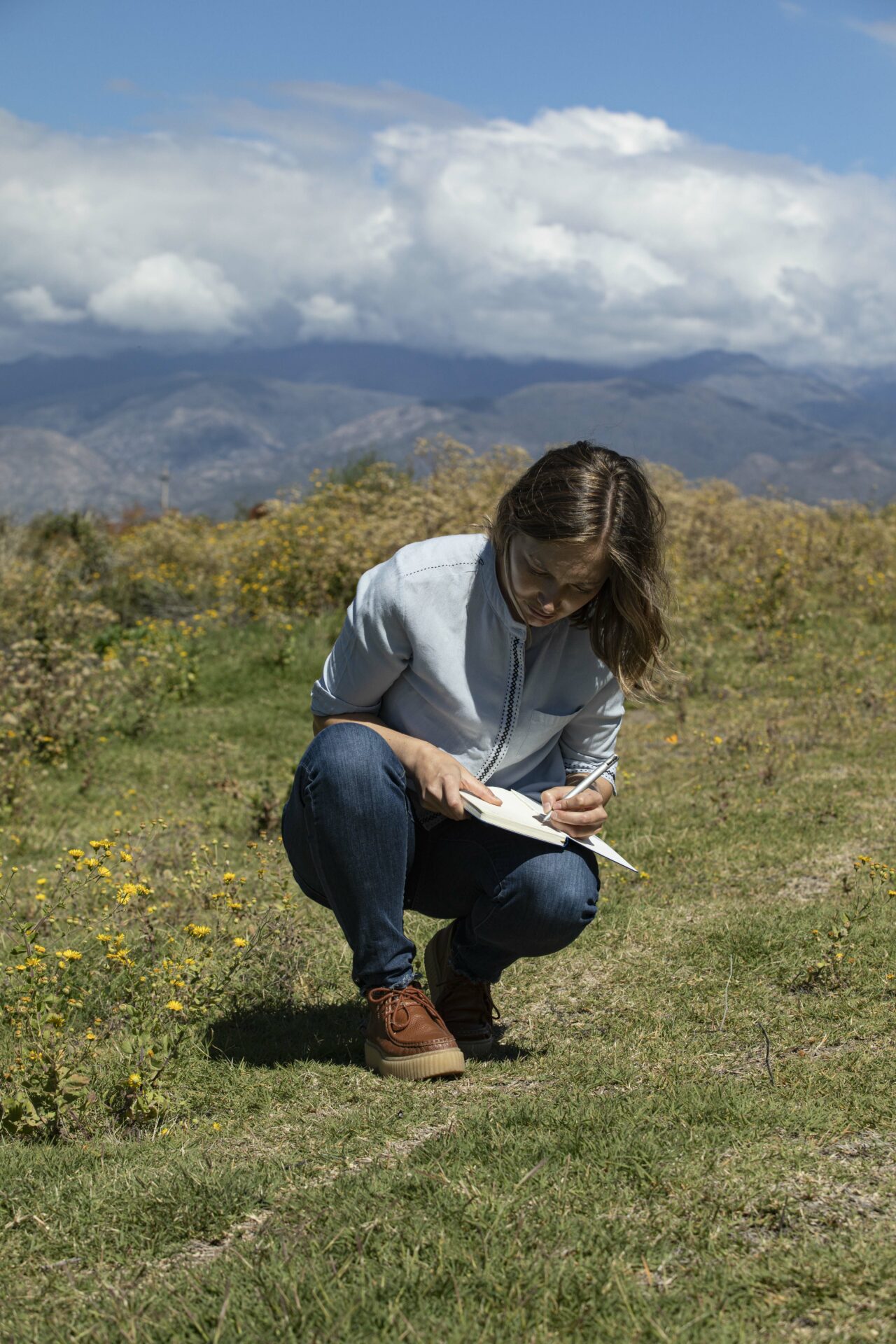 Guillermina Van Houten in the vineyards taking notes