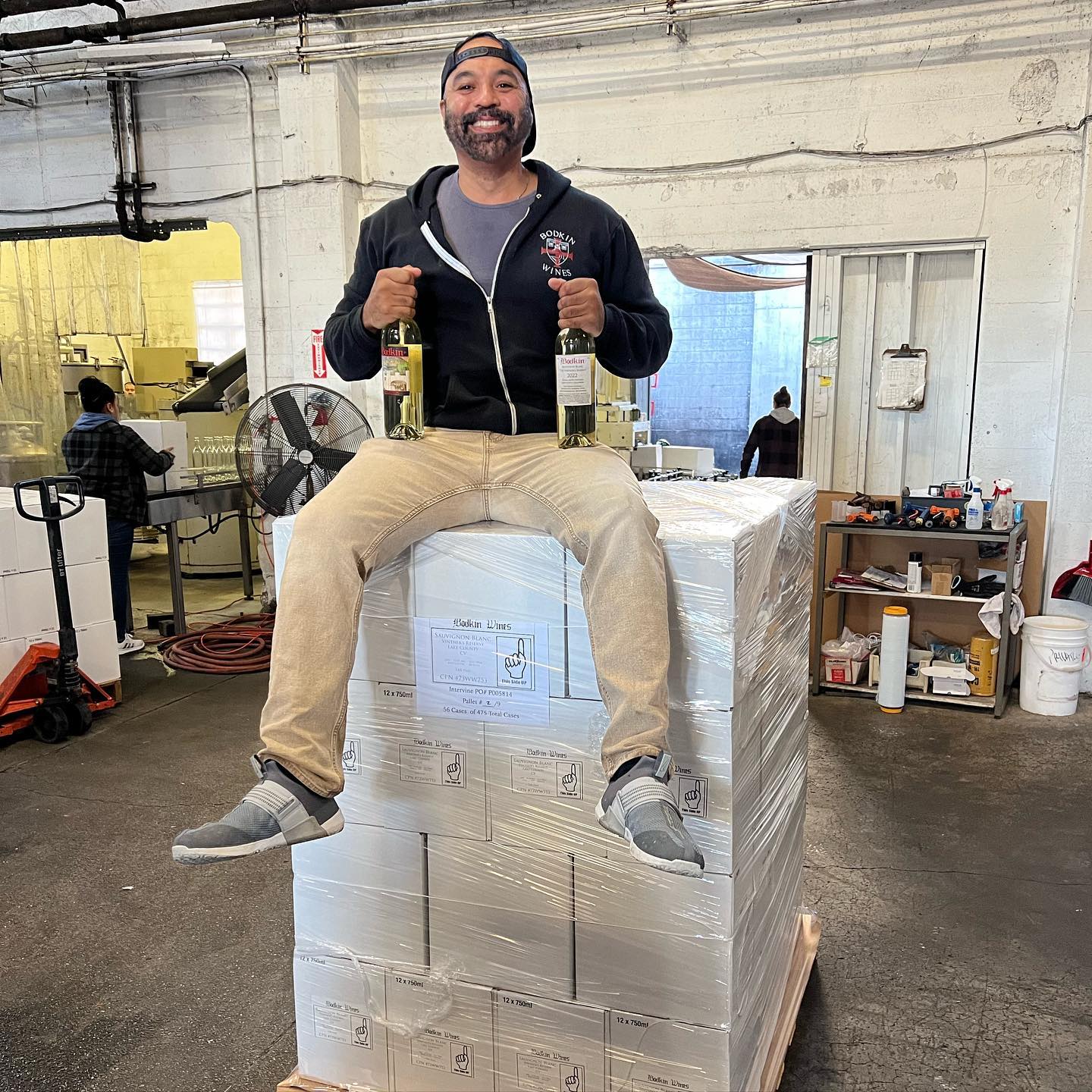 Chris of Bodkin Wines poses for a photo on top of wine crates