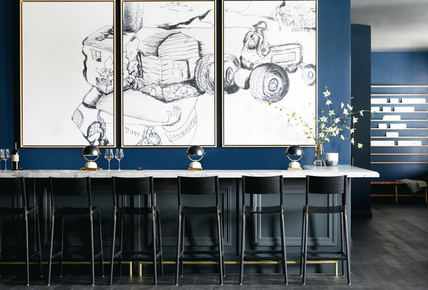 Indoor wine bar seating with art hanging on the walls