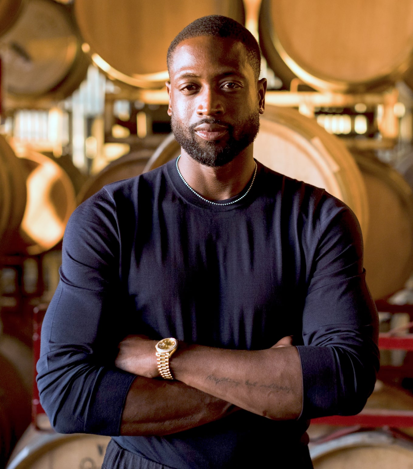 Dwayne Wade poses in front of wine barrels