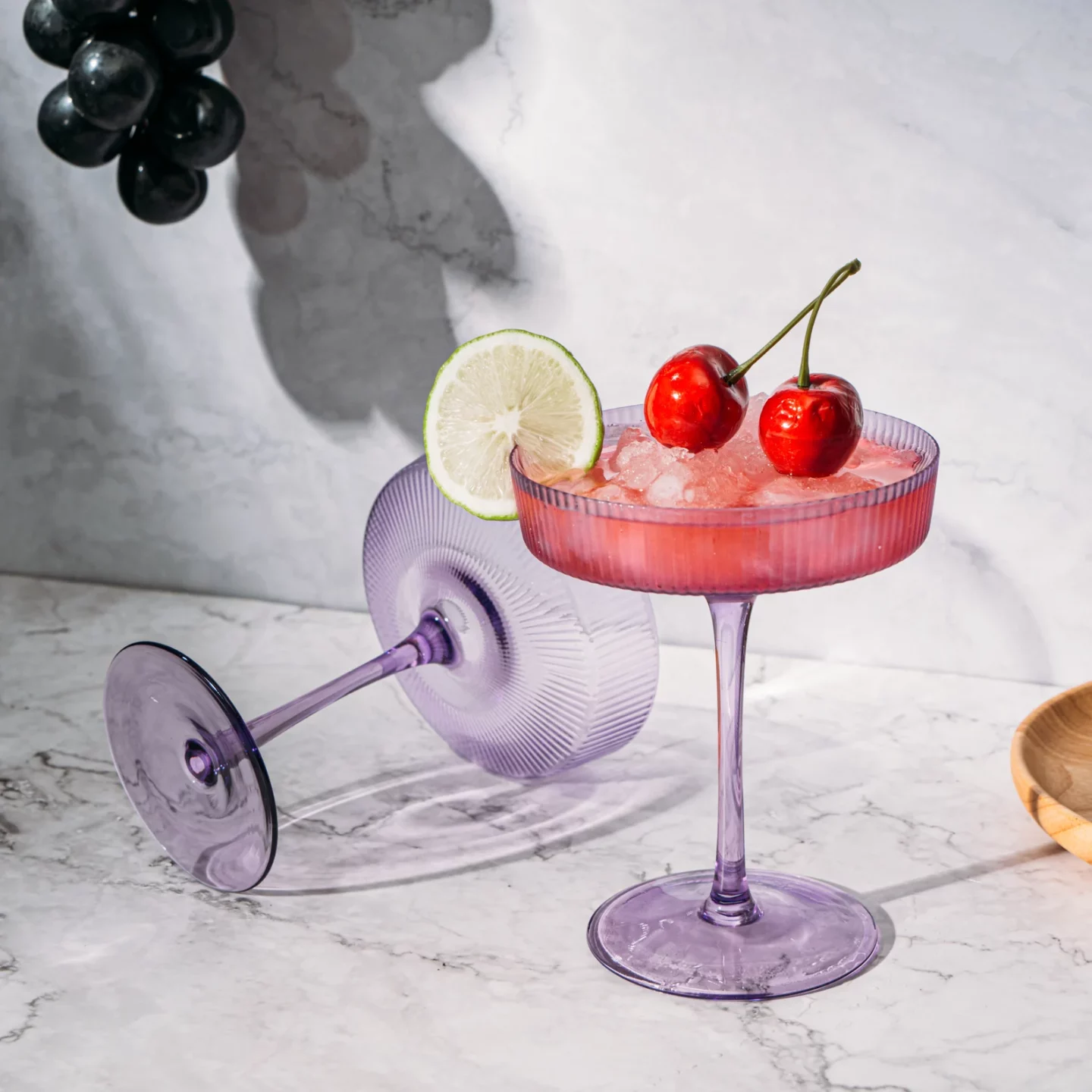 Lavender Coupe Glasses holding a cherry martini