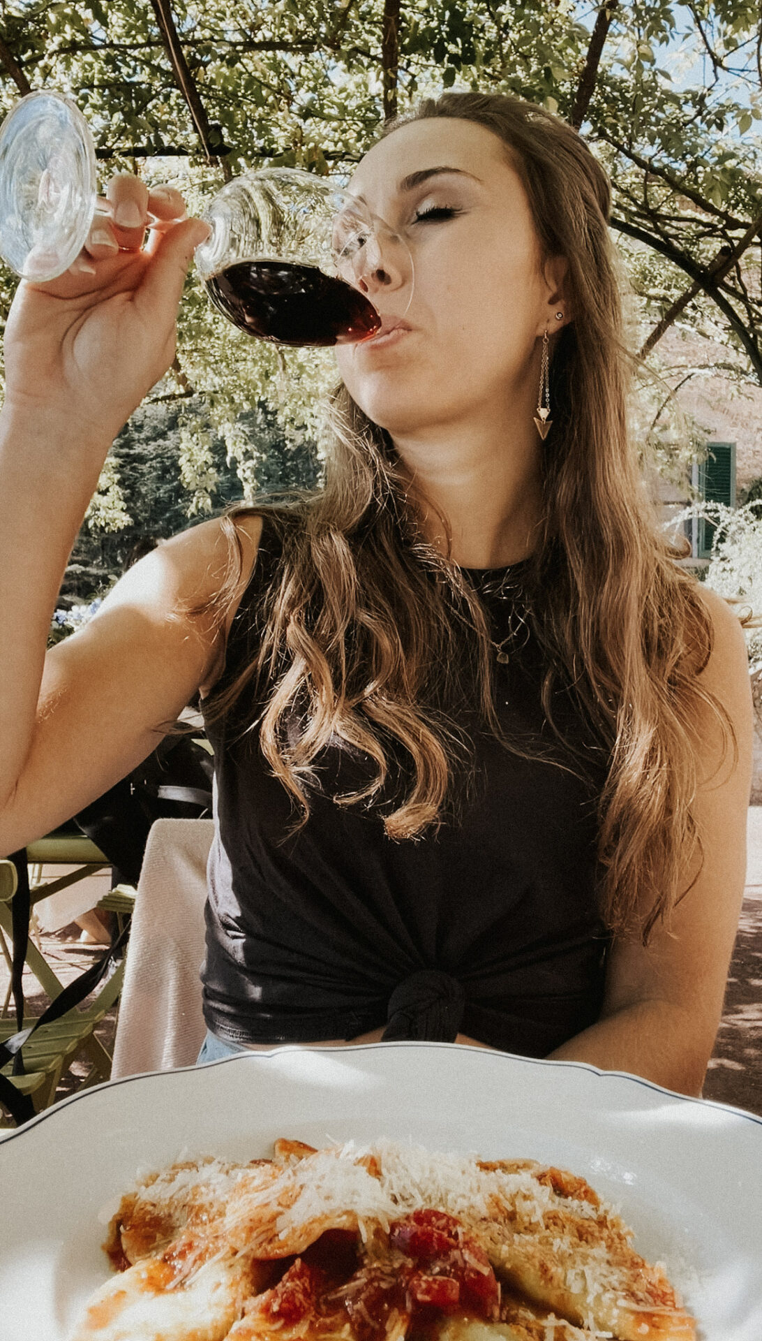 Paige Enjoying a Glass of Red Wine with Pasta