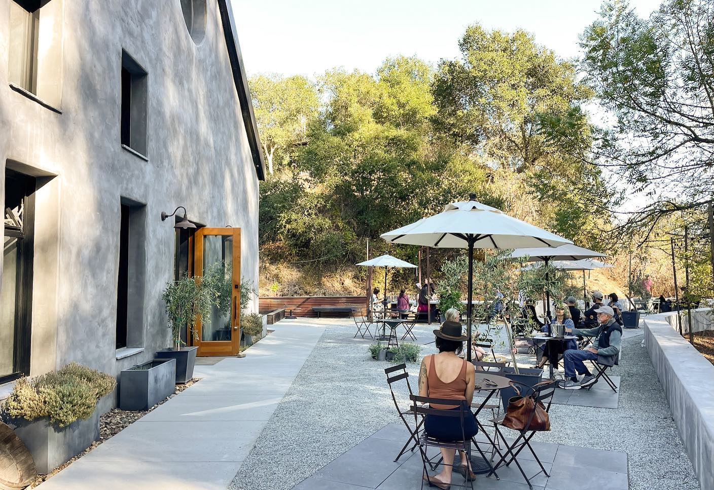 Outdoor patio seating with umbrella coverage at Storrs Vineyard and Winery in Santa Cruz Mountains