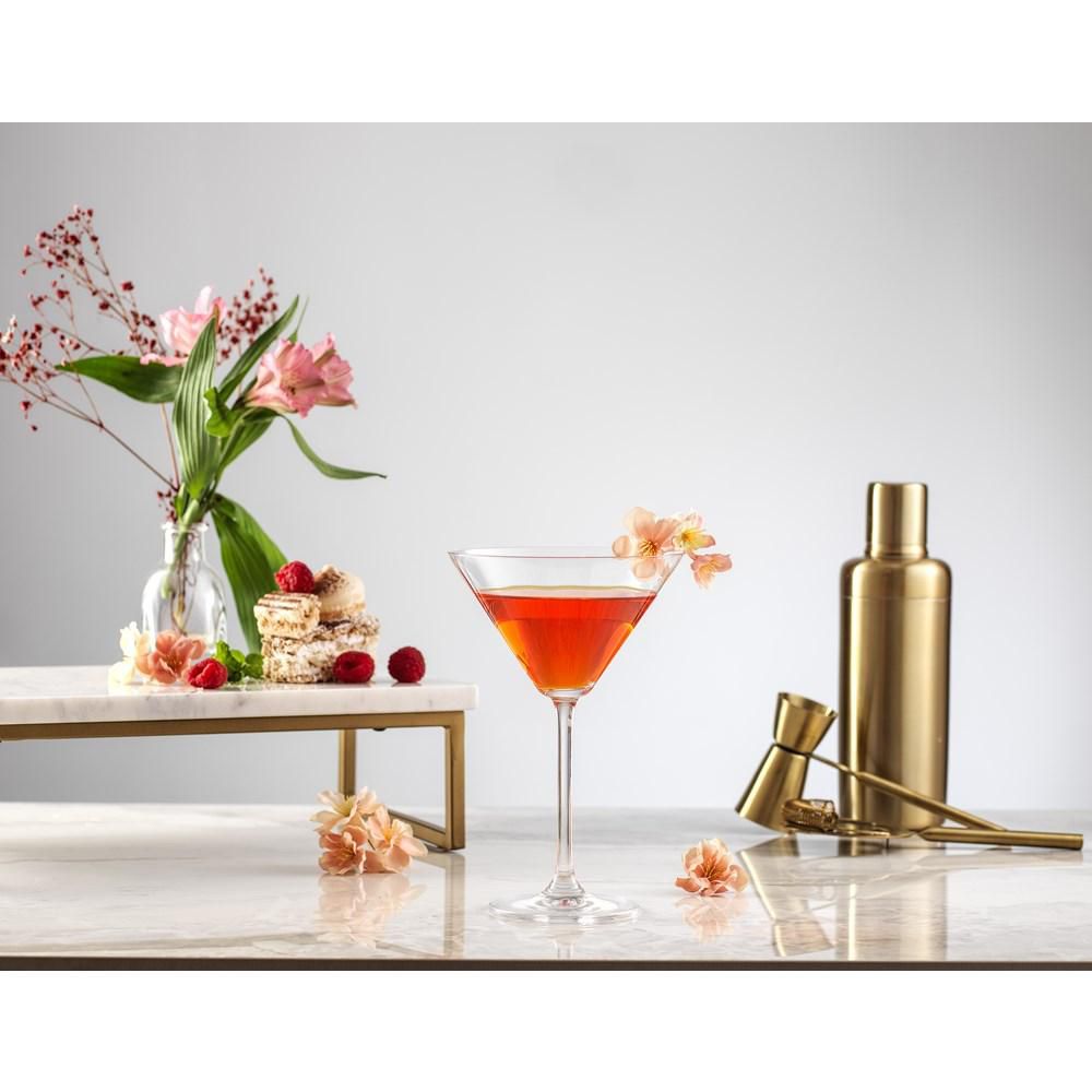 Cocktail pictured next to shaker and vase of flowers