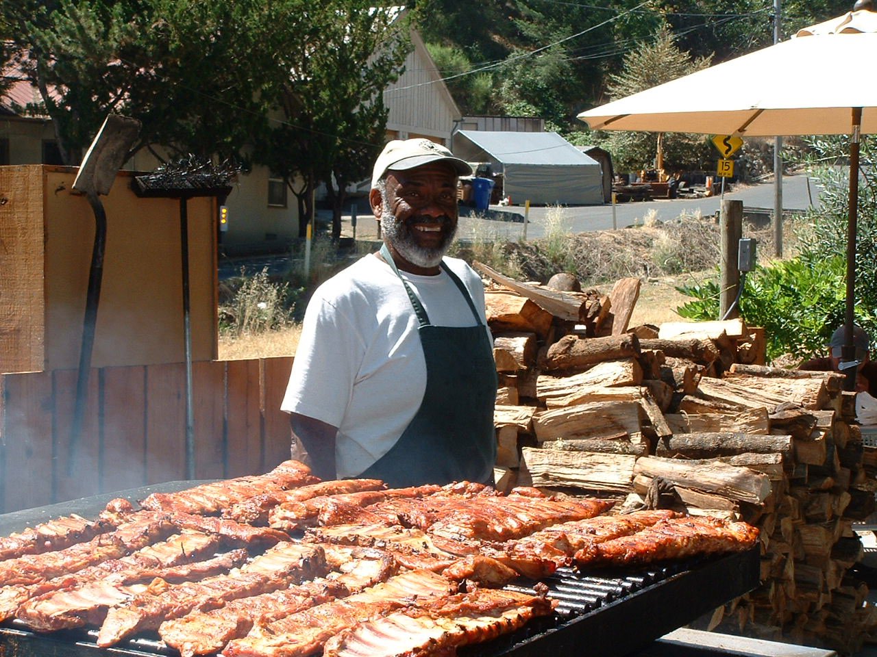 Buster standing behind an outdoor BBQ grill in Calistoga, CA