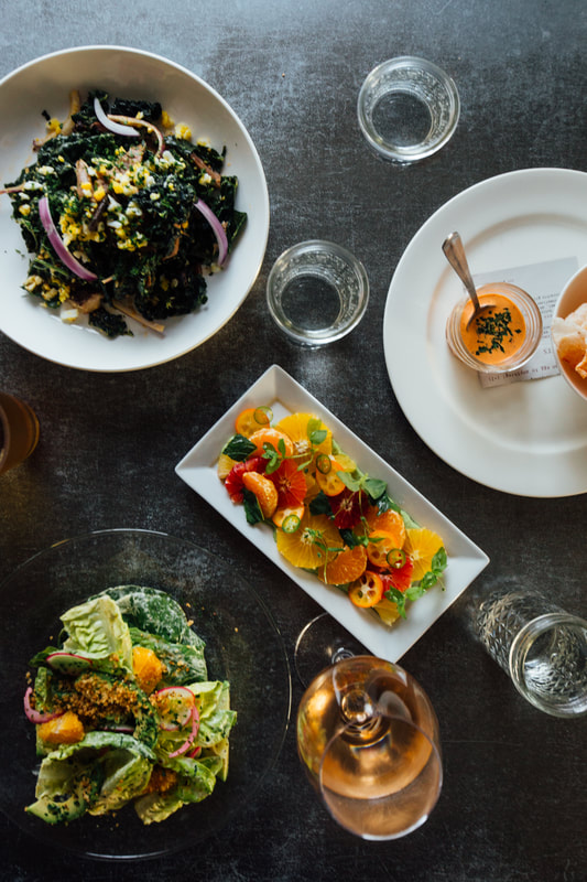 Ariel shot of various food dishes placed on a grey table